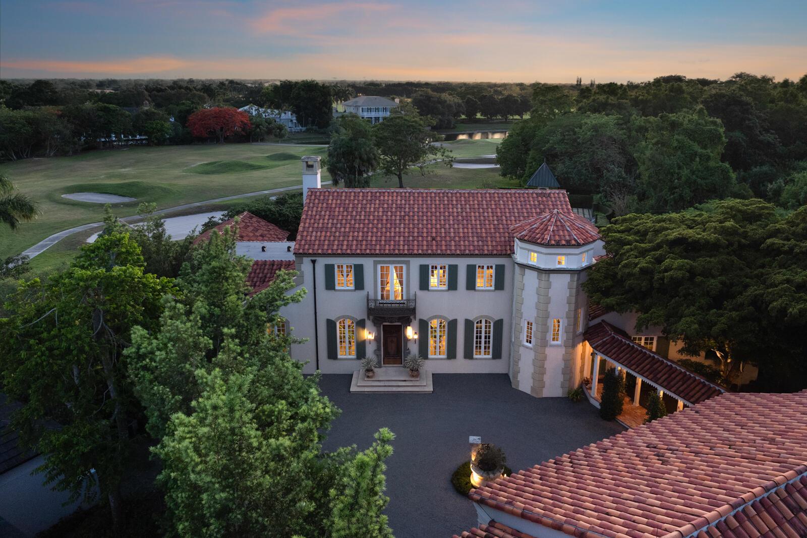 Within the highly coveted neighborhood of Bridle Path at the Polo Club, the property is set next to the 92-acre Cypress Preserve to the north and the golf course to the southwest, making it one of the best lots in Palm Beach Polo, with incredible views and privacy. The main house has 5 bedrooms and 5 1⁄2 bathrooms, while the coach house has 2 bedrooms 2 bathrooms. As you drive through the coach house, you see the octagonal turret, with its award-winning design by the American Institute of Architects. Through the 17th-century door, you find a grand hall with vaulted ceilings and fixtures sourced from Paris. Down the hall is the great room, with vaulted ceilings and fireplace, which opens to a large formal dining area. Just past the great room is the primary wing with an office and pr