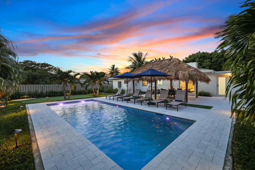 Attention investors! This fully furnished, high-performing luxury short-term rental in Delray Beach is a rare opportunity to own a top-producing income property. Purposefully designed and completely remodeled to maximize short-term rental revenue, this is not your typical single-family home—it's an established cash-flow machine, generating $155,000+ in the last year of operation. Based on AirDNA data, this property performs in the top 3-4% of short-term rentals in the area, making it an exceptional addition to any investor's portfolio. Featuring 3 spacious bedrooms, 3 designer-finished bathrooms, and a stylish open-concept living space, the home includes a true resort-style backyard that keeps guests coming back again and again.  The heated pool, travertine deck, tiki covered outdoor dining area, and professionally designed and built putting green creates the ultimate vacation experience. Located just a quick golf cart ride from downtown Delray Beach, this property is in a prime location for attracting high-dollar bookings. If you're looking for a turnkey investment property with proven income potential, this is the one or a perfect second home with rentability.