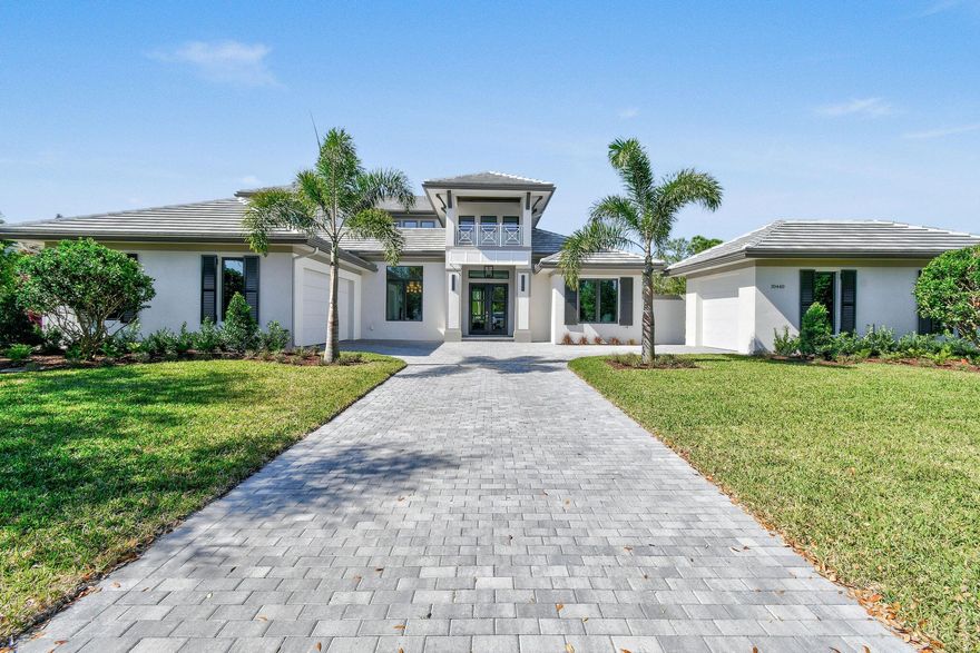 Exquisite New Construction home located in the sought-after community of Medalist Village in Hobe Sound. This spectacular brand-new estate, designed and built by the prestigious AR Homes, sits gracefully on just over 1/3 of an acre, offering privacy, elegance, and sophistication. Spanning over 6,000 total square feet, this thoughtfully designed residence boasts 5 spacious bedrooms, 5.5 beautifully appointed baths, plus a versatile den/office--creating the perfect balance between comfort and functionality. Designed for both grand entertaining and everyday living, this home features an open-concept layout with seamless indoor-outdoor integration.