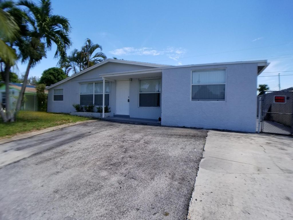 Photo of 1561 W 11th Street, Riviera Beach, FL 33404 (MLS # B26029069)