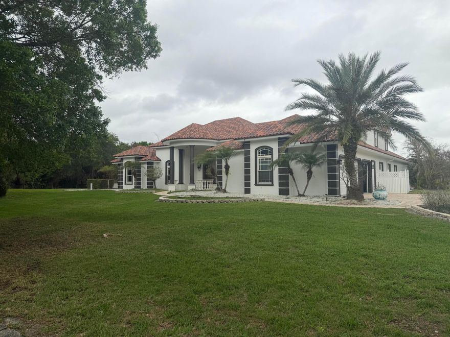 Rare Vero Beach acreage estate featuring 4.61 acres, a private stocked fishing lake, and a resort-style saltwater heated pool. This spacious 4-bedroom, 3-bath home with a 3-car garage offers privacy and endless possibilities. The property is agriculturally zoned, making it ideal for equestrian use, a nursery, hobby farm, or gardens. Expansive grounds provide plenty of room for horses, barns, additional outbuildings, RVs, boats, and recreational vehicles. Enjoy peaceful country living with scenic water views while still being just minutes from shopping, dining, golf courses, and the beautiful beaches of Vero Beach. A unique opportunity to own a versatile estate property with space, privacy, and lifestyle appeal.