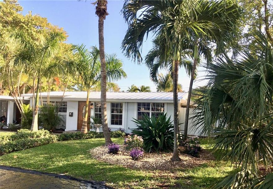 What a wonderful opportunity to own this renovated tropical oasis. The newly installed metal standing seam roof  and lush landscaping perfectly set the scene.Remodeled with SS appliances and impact windows and doors painted in/out, wood,marble and tile floors work to create the total picture.You are within one mile of excellent restaurants as well as great food and boutique shopping. Separate lockable en suite bedroom /outside door is perfect for guests. A green house style planting area off the kitchen and a south facing back yard is off the huge screened patio and deck and so many lovely garden areas wherever you look. Oasis(reuse water)property is inexpensive and environmentally sound.Large lot 9,350 s.f. with ample side and rear yards. You feel and smell the Ocean in your back yard Lots and lots of room for a pool  Location, Location, Location