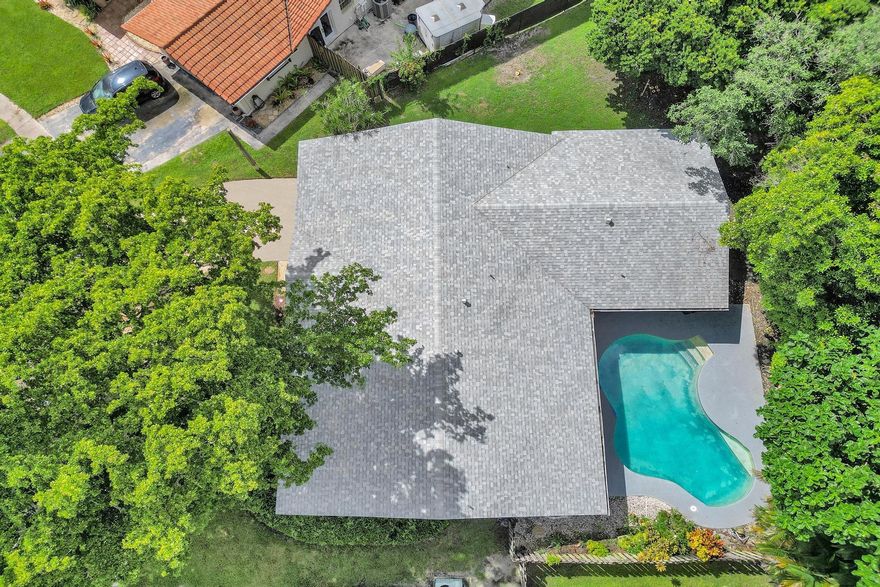 Bright, breezy, and beautifully maintained—this 4-bed, 2-bath gem in sought-after Plantation Hills offers the perfect blend of comfort, style-South Florida charm. With no HOA, enjoy true freedom on an oversized fenced lot bursting with mature lychee-mango trees. Light-filled interior features a spacious split floorplan, large living room, den, dedicated dining room perfect for hosting. The upgraded kitchen shines with granite countertops, rich wood cabinetry, and a cozy breakfast nook. Two cabana baths open to your private patio and sparkling pool—your backyard oasis awaits! New roof (2023), A/C (2020), new H/W, dedicated laundry room for convenience. Garage partially converted for extra storage. Prime location—walk to shops, dining, minutes to highways. Seller credit available—act fast!