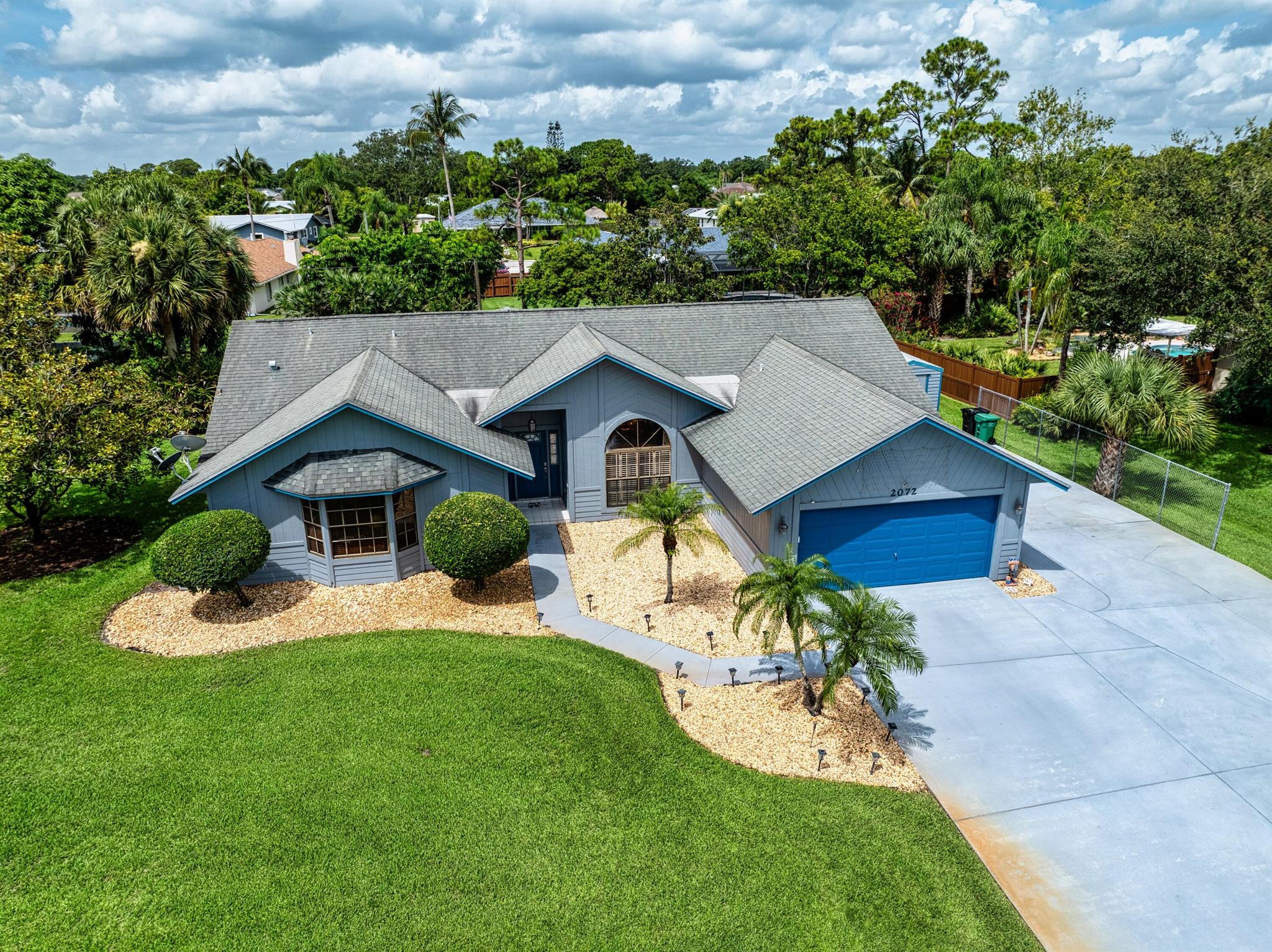 Nestled on a rare, nearly half-acre lot, this 3-bedroom, 2-bathroom home offers just under 2,000 square feet of thoughtfully designed living space with room to grow. The expansive property provides ample space for a pool, guest house, or simply enjoying the peaceful, private surroundings. Inside, laminate flooring flows throughout the home, complemented by custom window treatments and a central vacuum system for added convenience. The spacious kitchen features granite countertops, under-cabinet lighting, a built-in pantry, a built-in refrigerator, and a cozy eat-in area. covered and extended lanai, a tool shed with electricity, closet cabinet systems, a 30-amp RV outlet with dedicated parking slab, and a sprinkler system on a private well. The oversized master suite boasts dual walk-in