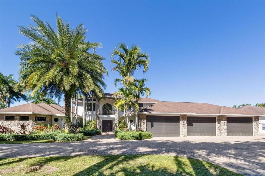 Beautiful waterfront home in gated equestrian community of Homeland. Enter through the front pivot door to be wowed by endless marble floors, soaring coffered ceiling, floor to ceiling wood burning fireplace and more. The home boasts a center island kitchen with separate breakfast area, snack bar & wine refrigerator. Quartz counters, Thermador 6 burner gas range w/center grill, 2 wall ovens, a built-in microwave and walk- in pantry closet are just some highlights the kitchen offers. The kitchen opens to the great room for casual living which extends to the fabulous resort like patio with built in BBQ and summer kitchen. A freeform pool with rock features and waterfall adds to the ambience created by the tiki bar & fire pit,  (continued)