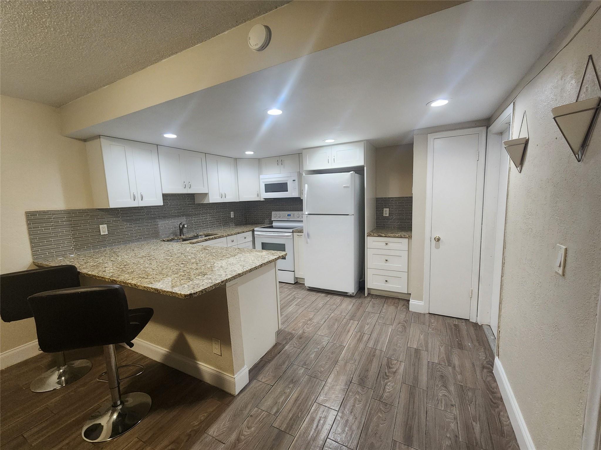 This renovated 2-bedroom, 2-bathroom first floor unit is located in the heart of a vibrant and highly sought-after community, offering the perfect blend of modern elegance and everyday comfort. With stylish updates throughout, this move-in-ready unit features an inviting layout and a private, cozy patio, ideal for relaxing or entertaining guests. Just steps from your door, enjoy access to 2 resort style community pool that makes every day feel like a getaway. Conveniently situated near shopping, dining, and entertainment, this unit is perfect for those seeking convenience of 2 assigned parking spots and ample guest parking. Common laundry facilities. Don’t miss the opportunity to make this gem your own!