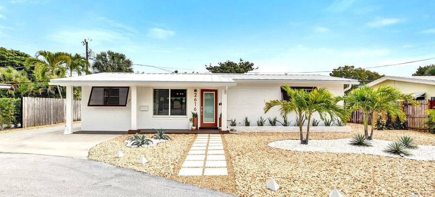 Location, Location, Location! Just steps to "The Drive's" restaurants, bars, shops, Publix & CVS. This charming open concept 3 bedroom, 1 bath home is nestled on a secluded cul-de-sac. All impact windows & doors. Re-engineered with precision in 2025 inside & outside. White metal roof (2025) with roof to wall tie downs giving maximum HURRICANE PROTECTION & maximum electricity savings. Updated kitchen & bathroom. New exterior paint, Bahama shutters, PVC columns, rain gutters. Professionally landscaped Palm Springs style yard for easy, low cost maintenance! Updated electric including outdoor motion sensor security lighting. Newer central AC. 9'x9' indoor laundry/storage room with space for a 2nd bathroom. Be the lucky owner/investor to have a carefree & close to everything lifestyle!