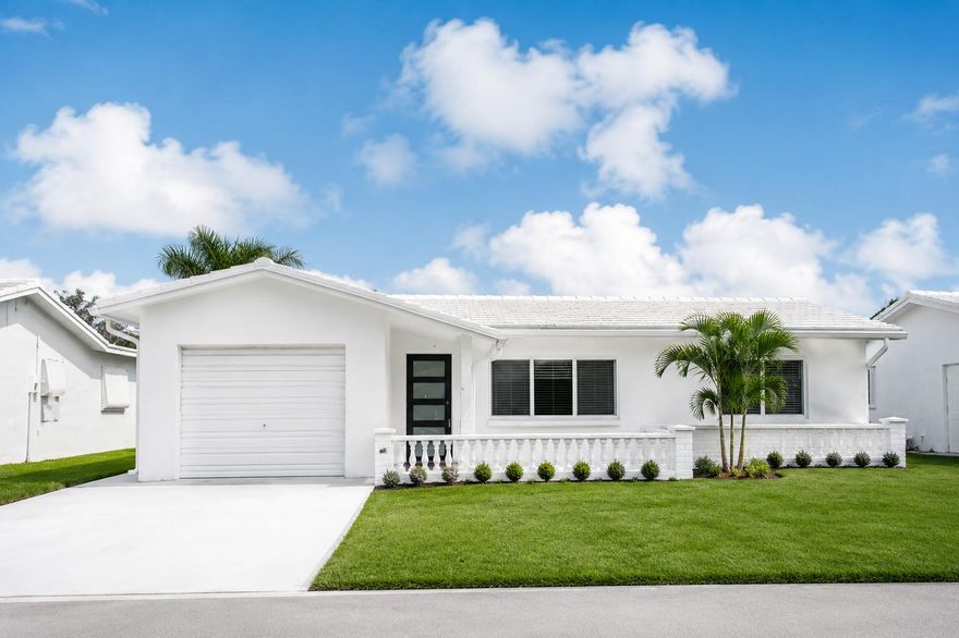 WELCOME TO YOUR FULLY REMODELED SOUTH FLORIDA RETREAT IN THE HIGHLY DESIRABLE LEISUREVILLE COMMUNITY OF BOYNTON BEACH!    Located just minutes from the beach, waterfront dining, shopping, parks, golf, hospitals, and major highways, this stunning move-in ready home offers the perfect combination of luxury, comfort, and lifestyle. Completely remodeled inside and out with designer finishes throughout, this property is truly one of the best values currently available in the area — and opportunities like this do not last long. Enjoy peace of mind with ALL NEW IMPACT WINDOWS AND DESIGNER HURRICANE DOORS, a NEW $30,000 ROOF, tankless/endless hot water heater, new landscaping, epoxy driveway, recessed lighting, and gorgeous oversized marble-look groutless tile flooring throughout the entire home. The bright open-concept layout features retractable ceiling fans, keyless entry, finished garage, cordless window shades, and elegant modern touches in every room. The beautifully upgraded kitchen is designed to impress with quartz countertops, all new cabinetry, farm sink, designer faucet, convection oven with combo microwave, new appliances, and a premium refrigerator that makes CRAFT ICE. The luxurious bathrooms feature a zero-threshold curbless shower, glass shower doors, floating vanity, and illuminated fogless mirrors for a true spa-like experience. The versatile back room can easily convert into a third bedroom, office, or media room — adding even more value and flexibility to this incredible home. Residents enjoy resort-style amenities including FREE GOLF COURSE access, pools, hot tub, clubhouse, fitness center, billiards, ping pong, and an active social lifestyle in one of Boynton Beach's most convenient locations. Minutes to: • Beautiful South Florida beaches   • Restaurants & waterfront dining • Shopping centers & supermarkets • Bethesda Hospital & medical facilities • Public parks & recreation • I-95 and major commuter routes THIS IS THE KIND OF PROPERTY BUYERS WAIT FOR — FULLY UPDATED, LOW MAINTENANCE, PRIME LOCATION, AND PRICED TO ATTRACT ATTENTION FAST. SCHEDULE YOUR PRIVATE SHOWING TODAY BEFORE THIS EXCEPTIONAL OPPORTUNITY IS GONE!