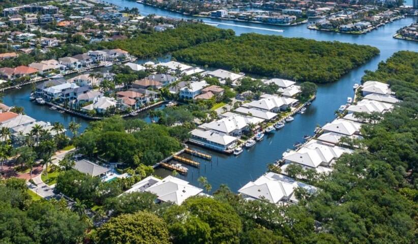 The best water views in Boca Marina Yacht Club. Your private 60' dock allows you to experience the ultimate waterfront lifestyle living in this hidden gem nestled in a lush paradise. This exclusive community boasts deepwater access with no fixed bridges, providing seamless ocean navigation. Revel in breathtaking water views and the convenience of your own private 60' dock, fulfilling every boater's dream.This exquisite 3-bedroom, 3-bathroom waterfront villa is situated on a spacious .23-acre lot adorned with stunning trees and meticulous landscaping. With endless potential, this villa awaits your personal touch to transform it into a masterpiece.