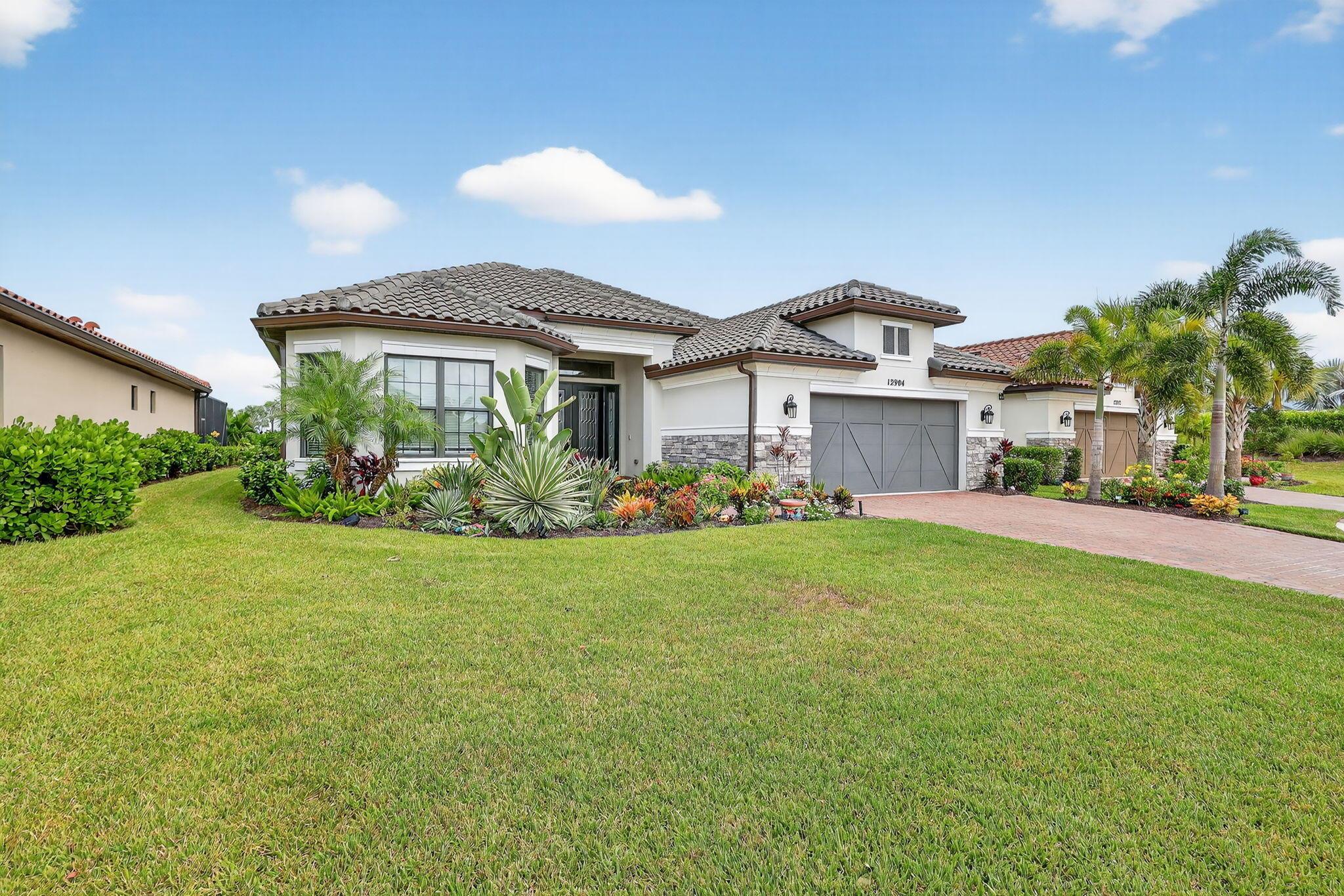 This home is a must see. Located toward the end of the cul-de-sac, this is one of the best waterfront lots in the community. Very private with no homes on opposite side of lake. This 3 year old extended Palazio model offers open concept. Owner added over $200,000 in upgrades and it shows. Gourmet extended kitchen, custom lighting, built-ins in office & laundry room, electric sliding door treatments & custom garage floor. Step out on the screened in Lanai with summer kitchen for entertaining. Rear yard is fenced for you & your pets enjoyment. Full list of upgrades available on request.Esplanade is a 55 plus community like no other. Concierge services for residents and a lifestyle coordinator for the activities. Enjoy the clubhouse, pool, spa, fitness center, tennis, pickle ball,
