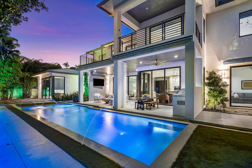 Wake up each morning wrapped in luxury in this newly built coastal modern masterpiece by Bella Homes on a private cul-de-sac lot in the enviable neighborhood of Lake Ida. This 5 bedroom, 5.1 bathroom home provides the perfect backdrop for the multitude of memories you'll make in it. Every inch is dedicated to enjoyment of this impeccably planned oasis. Masterfully crafted with superb attention to detail, this home is luxury defined. Entering through the volumous, two-story glass foyer, you'll be drawn to the Bella Citta eco-friendly wood floors and allow the brilliant natural light that flows through floor to ceiling windows wash over you. Natural touches make their way through the home's 3,869 square foot open floor plan, where hints of wood, glass, and stone can be found throughout. The custom designed modern kitchen features a beautiful reclaimed wood and stone island that changes colors at the touch of a button. In addition to clean lines and modern finishes, a Jenn-Air appliance package, ample storage, and a spacious walk-in pantry make this home the perfect spot for casual living and gracious entertaining.

A wall of impact glass sliding doors trace the back wall of the home's first floor, seamlessly blurring the lines between interior and exterior. Dine inside or al fresco beneath the inviting covered patio that features a summer kitchen and luxurious resort style pool. Automated awnings on both levels provide additional shade to enjoy your lush private oasis with constant ocean breezes. You can even work on your golf game in the 6-hole putting green or workout in the covered outdoor gym space.

The first floor master suite with lush tropical garden views is an owner's dream with his and hers walk-in closets, sliders to a private patio, and a light and bright, spacious master bathroom. An office/5th bedroom with private ensuite bathroom is on the first floor as well and has gorgeous views of the backyard. The second level has 3 additional bedrooms all with private ensuite bathrooms and provide ample space for family members and guests. The loft provides an upstairs family room with an extensive second outdoor space with a balcony for viewing and enjoying sunsets.

Built in 2019, this home features expansive modern amenities including a whole house generator, whole house water filter system, Control 4 smart home remote, security cameras, Sonos surround both inside and out, an alarm system and much more.

This expansive home full of architectural charm is in the Lake Ida community and is just a short bike or golf cart ride away from Atlantic Avenue, Pineapple Grove, and the Beach!

The information published and provided including but not limited to prices, measurements, square footages, lot sizes, features, finishes, and calculations are subject to errors, omissions or changes without notice. All such information should be independently verified. All parties should perform their own due diligence to verify all information.