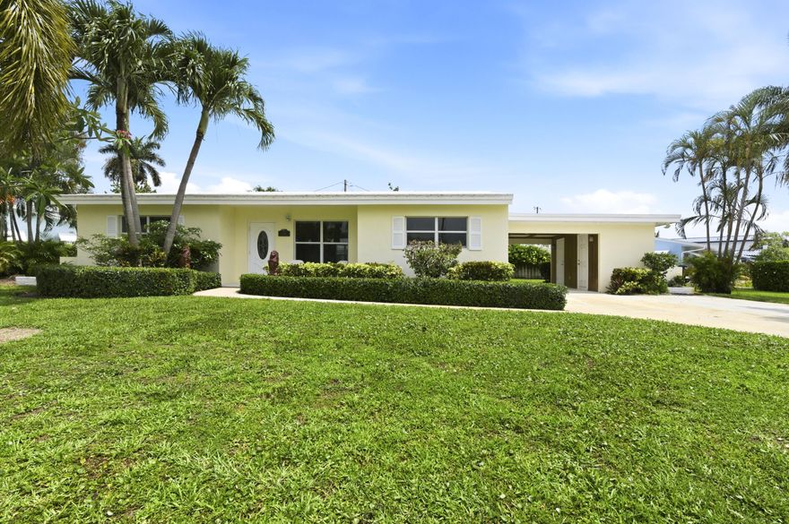 Pride of ownership shines throughout this immaculate 3BR/2BA Mid-Century Modern home on a corner lot with views of Lake Osborne. Move-in ready with an updated kitchen featuring stainless steel appliances, diagonally laid tile flooring, hurricane impact windows, upgraded electrical, 2019 A/C, 2016 tile roof, 2022 flat roof, and 2018 water heater. Relax on the beautiful patio and enjoy lake breezes year-round. Additional features include a large utility room with washer/dryer, automatic well sprinkler system, and accordion shutters on French doors and laundry room. NO HOA and conveniently located near I-95, shopping, dining, beaches, Palm Beach International Airport, and all Palm Beach County has to offer.