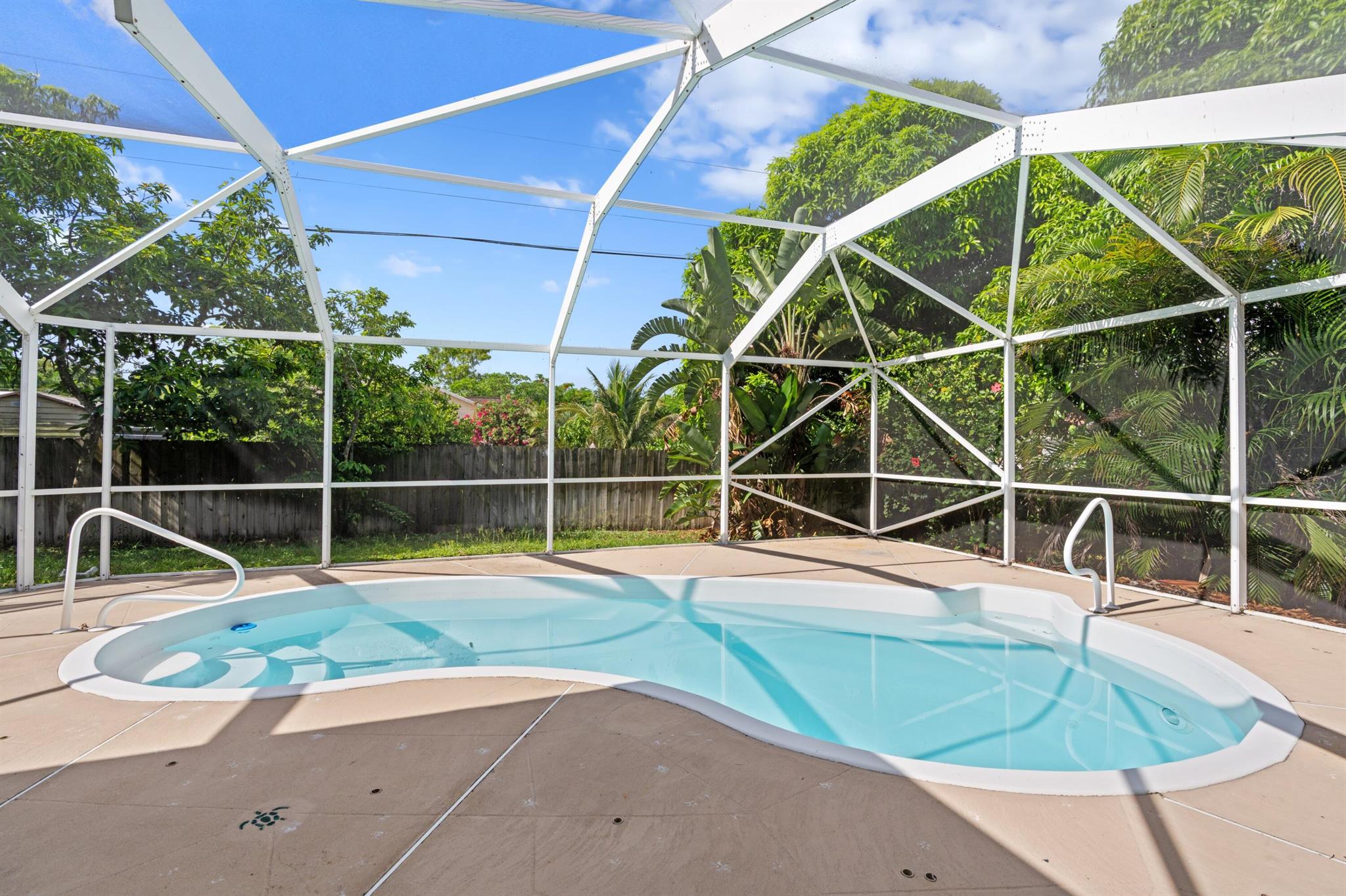 Welcome to your dream home! This beautifully updated 4-bedroom, 3-bathroom residence offers 2,000 square feet of light-filled living space and sits on a rare and expansive quarter-acre corner lot. With a new roof, new A/C, and new underground PVC plumbing, peace of mind comes standard.Step inside and be immediately impressed by the spacious, open floor plan with direct views of the sparkling inground heated saltwater pool and lush backyard. Soaring natural light floods every room, while the split-bedroom layout ensures privacy and comfort for the whole family.