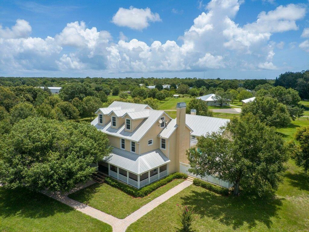Welcome to this exquisite private, one of a kind custom 5-bedroom, 4.5-bathroom home nestled on 5 acres of pristine land in one of the most desirable neighborhoods in town. This stunning property is a true masterpiece, boasting luxurious finishes, exceptional craftsmanship, and breathtaking views. The main house features an open and spacious floor plan that seamlessly integrates the indoor and outdoor living spaces. The family room features trey ceilings, a cozy fireplace, French doors onto the porch and pool deck and large windows that flood the space with natural light. The formal dining and living rooms feature pocket doors to separate the formal areas. Both have trey ceilings and the dining room features wainscoting. Both formal rooms open onto the wraparound front porch. The gourmet