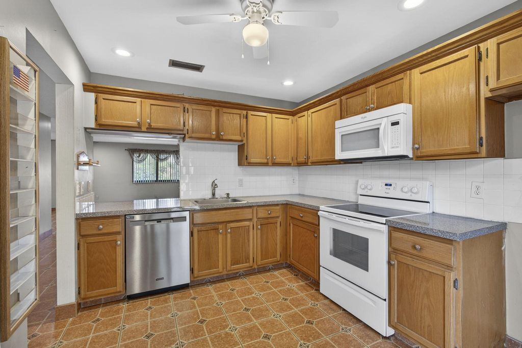 Photo of 67 Macadamia Court, Royal Palm Beach, FL 33411 (MLS # B26019023)