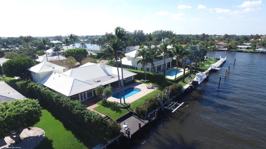 Ideally set in Gulf Stream this home really has it all representing the best waterfront value! An easy stroll to the ocean or a short distance to Gulf Stream School.. a perfect location. Bound with privacy, features include a large open living room with loads of natural light & full width sliding doors opening to an oversized loggia for relaxing and enjoyment. Additionally, there are 4BB including a first flr master suite,  European styled kitchen with custom cabinetry and adjacent family room with pool and loggia access, climate controlled wine cellars, office, limestone floors, tray ceilings, crown moldings and impact windows. Private courtyard entry, large tropical pool, 20,000 pound boat lift with dock on deep water make this home an incredible value. Full house generator. Wait no more