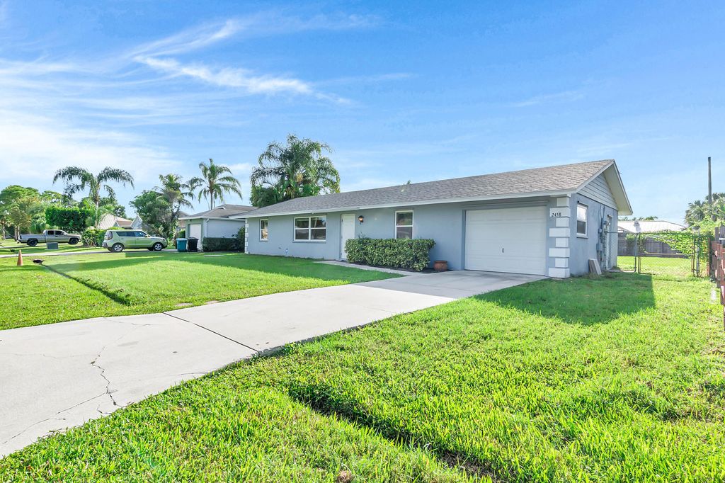 Photo of 2458 SW Hinchman Street, Port Saint Lucie, FL 34984 (MLS # R11124620)