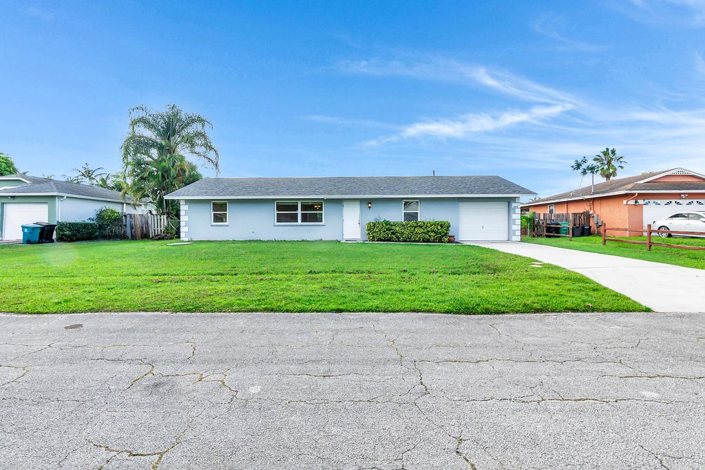 Photo of 2458 SW Hinchman Street, Port Saint Lucie, FL 34984 (MLS # R11124620)