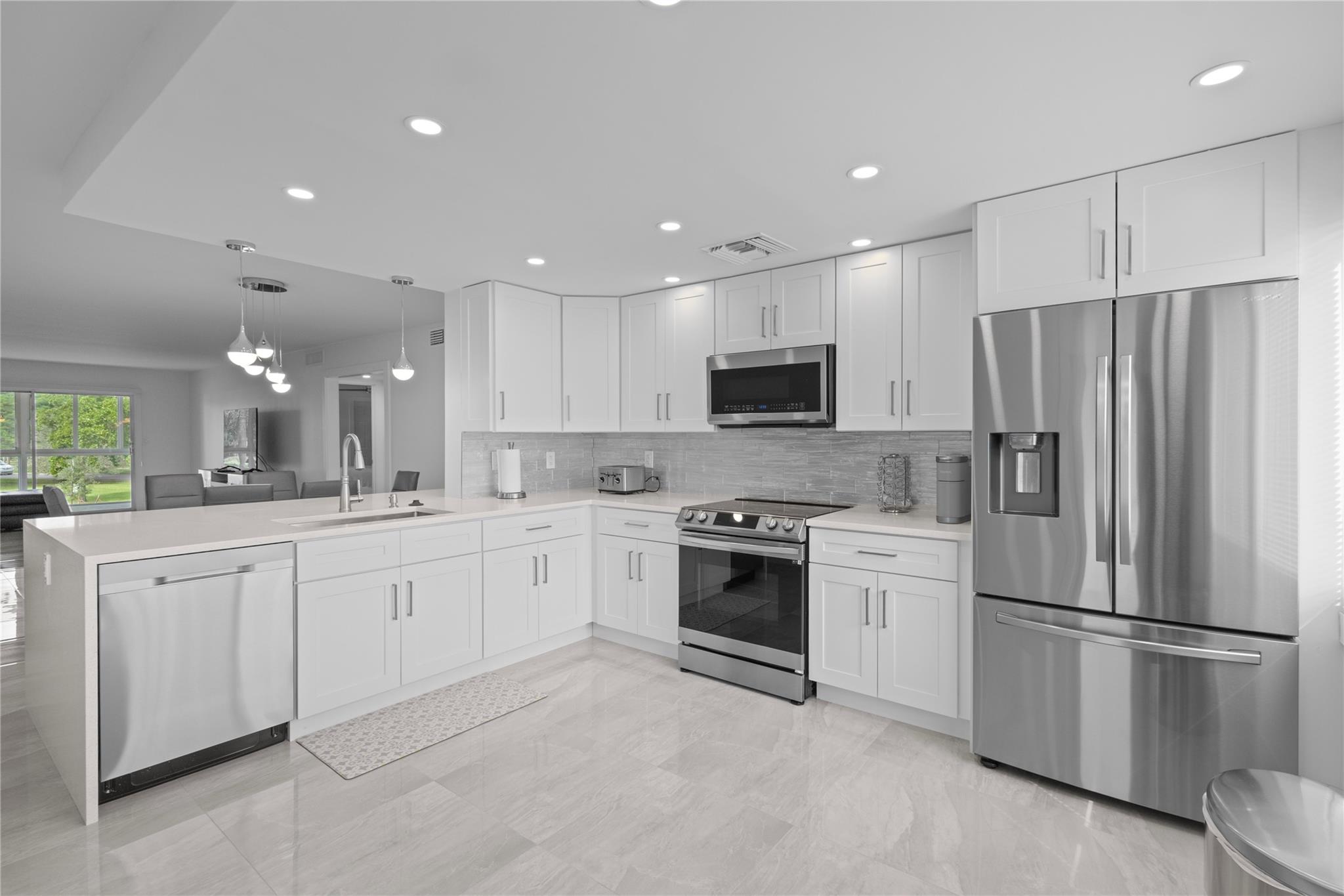 Spacious 2/2 corner unit on the second floor with a serene lakefront view!  Completely upgraded with custom finishes and all impact windows, doors and patio.  Quartz waterfall countertop with Samsung appliances.  Large, sparkling porcelain tile throughout with vinyl tile floors in both oversized bedrooms.  Automatic blinds/shades in living room and master bedroom.  Jaw dropping view of the sunset mirrors the lake in the evening.  Easy access to all amenities in the neighborhood, including clubhouse, golf, tennis, billiard, pools, etc.  One reserved parking space with ample parking for guests.
