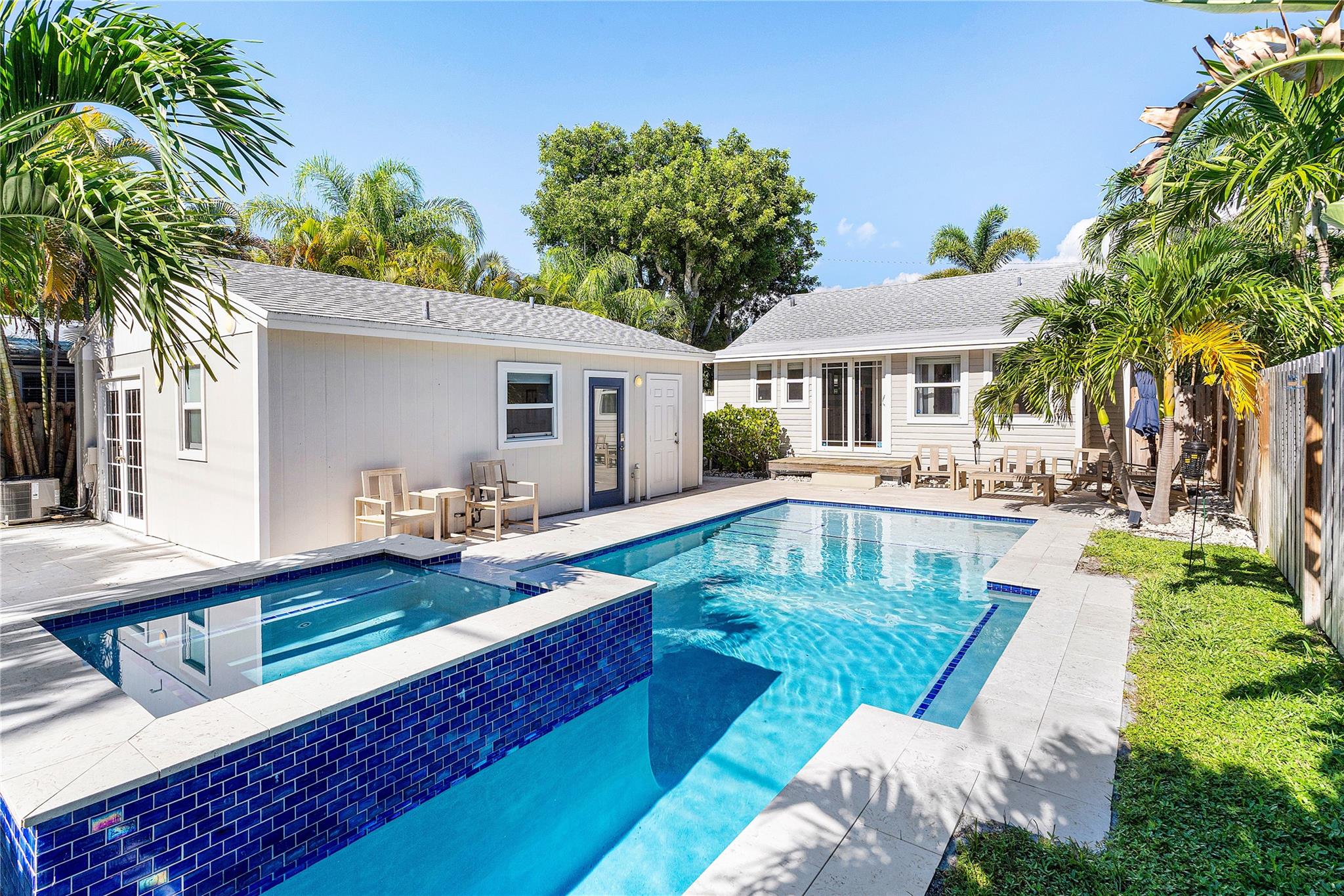 Beautifully restored 1930s Lake Worth Beach cottage that functions as a modern single-family home. Includes separate in-law suite and a brand new custom heated pool with limestone deck. Main home is 2-beds, 1.5-baths paired with a fully equipped 1-bed, 1-bath in-law suite perfect for guests, extended family, or income potential. Every detail thoughtfully updated while preserving the warmth of its original design with refinished Dade County Pine hardwood floors and classic architecture throughout. UPGRADES: Custom heated Gunite Pool w/ 6-Jet Spa & Limestone Deck (2022), All PVC/Copper Plumbing (2022), App-controlled Irrigation System (2022), Roof (2019), HVAC (2019), Full Impact Windows/Doors. In the heart of historic Lake Worth Beach, golf courses, parks, restaurants, and the intracoastal.