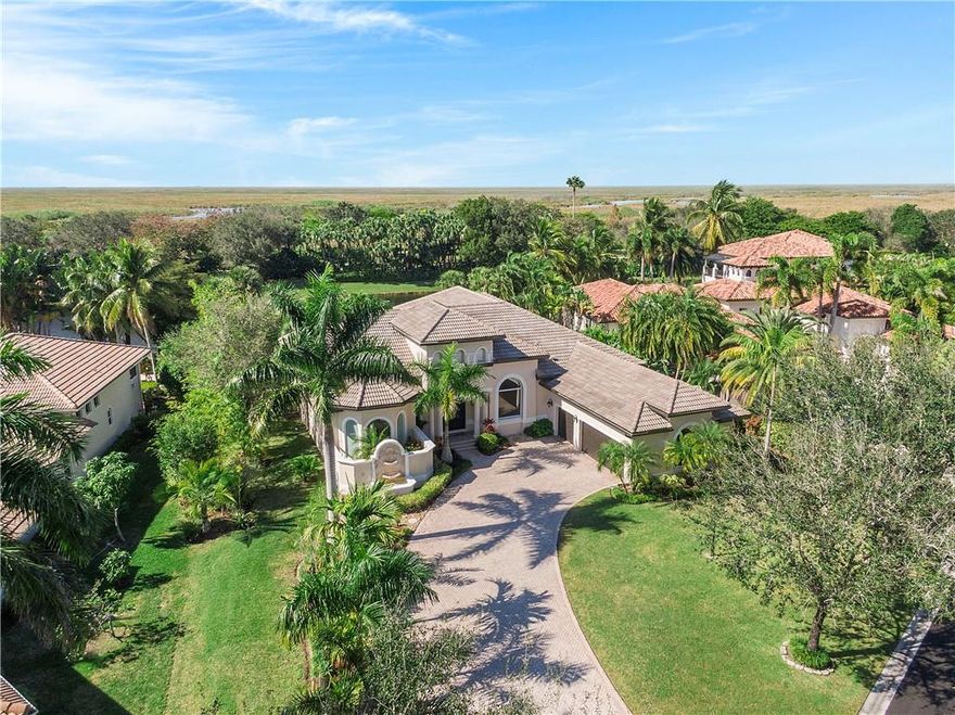 Prestigious Custom built "Colony" Estate in "Parkland's only double gated community in Heron Bay" 5 bedrooms, +office, This home nestles on a manicured landscaped 20,209 sq foot lot with miles of preserved land behind and no neighbors behind, The lake is completely private & serene, Spectacular LED custom designed pool & screened-in patio & summer kitchen, Hurricane impact protection throughout, Marble flooring in living areas &  wood flooring in bedrooms & office, Pool & lake view from master bedroom w/sitting area, large master bathroom w/double walk in shower & vanity sinks, Soaking tub, Wood kitchen cabinets with granite countertops, Stainless appliances, Double ovens, breakfast bar seating, Beautiful matching built in cocktail bar with full service fridge & sink, Smart home, A+Schools