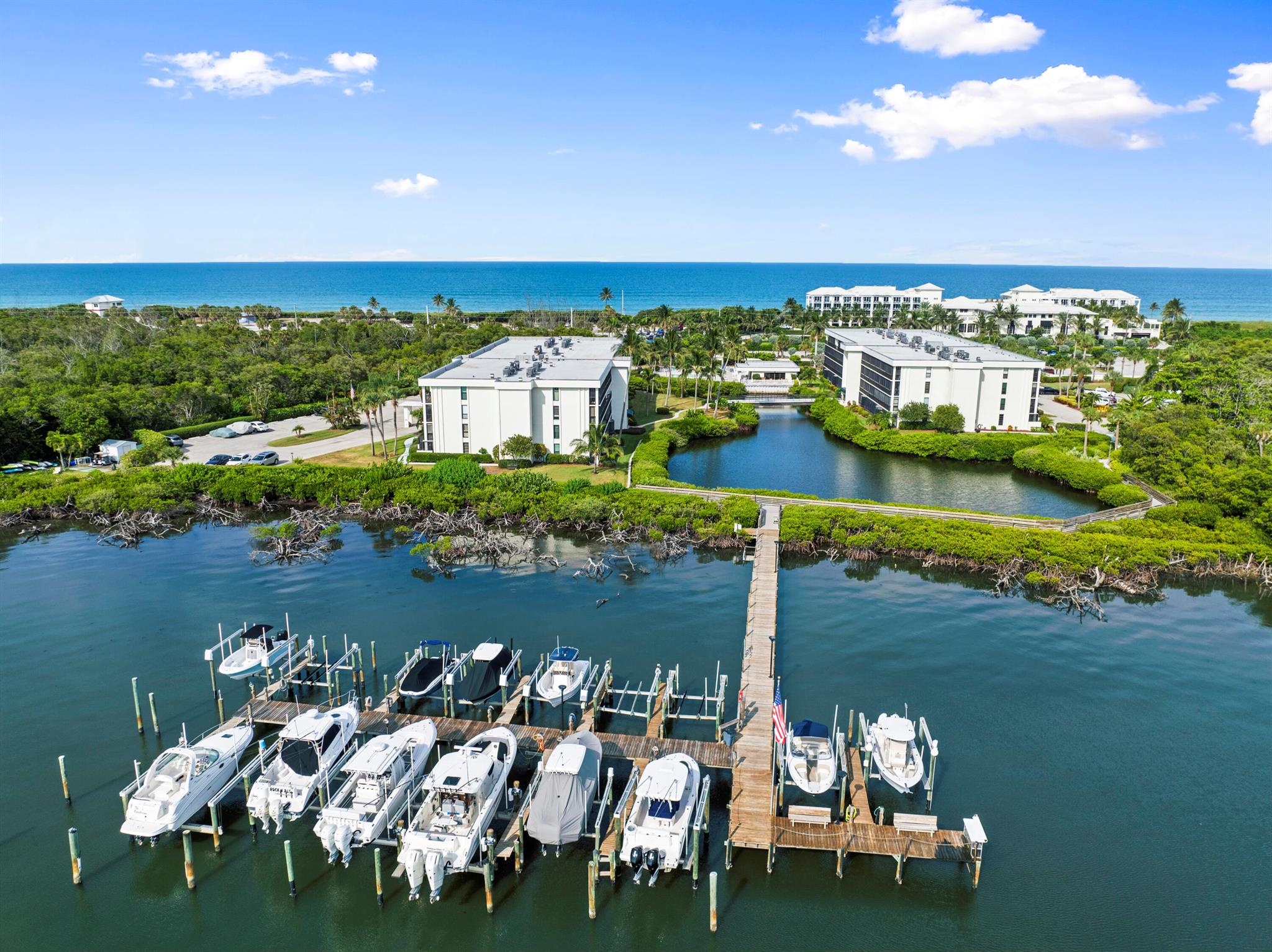 Waterfront 2Bed 2Bath condo with spacious patio. Dock slips up to 40' boats on the Indian River upon availability. Located across from Hutchinson Shores Resort & Jensen Beach with public access. Comm. Marina, Clubhouse, Heated Swimming Pool, BBQ & Gym. Fully furnished Tommy Bahama inspired decor. Kitchen has white cabinets, SS appliances, white counters & SS backsplash. Porcelain tile wood plank floors. Beverage cooler, and wine chiller. Main suite features PGT impact sliding glass doors to patio spacious, walk-in closet and second standard closet. Main bath has been renovated with new vanity and vessel sink. Roof 2025, Hot water heater 2024 & A/C in 2009. Stack washer dryer in unit.
