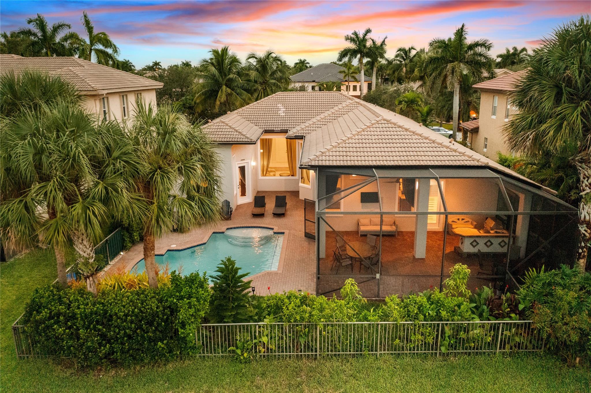 Lowest Priced Parkland Pool Home Over 3,000 SqFt! Popular 5 Beds, 3 Baths Tri-Split Floorplan w/Swimming Pool, On Waterfront Lot w/3 Car Garage. Expanded Pavered Screened-In Patio w/Built-In Summer Kitchen Ideal For Entertaining, Soaring 14 Ft Ceilings, Primary Bed w/Sitting Area, Walk-In Closets w/Built-In's w/Updated Ceramic Tile, Primary Bath w/Separate Jetted Tub & Shower, Dual Sinks, Updated A/C Unit, Partial Impact Windows & Shutters For Full Hurricane Protection, Spacious Kitchen w/Granite Counters & Large Island, Built-In Bar & Wine Fridge, Jack & Jill Beds & Bath, Lush Landscaping, Fenced In-Lot, Resort-Style Amenities Including 2 Clubhouses, Fitness Center, Heated Pool & Jacuzzi, Kids Spray Area & Playgrounds, Event Rooms, Tennis, Basketball, Pickelball, Racquetball, & Tiki Bar.