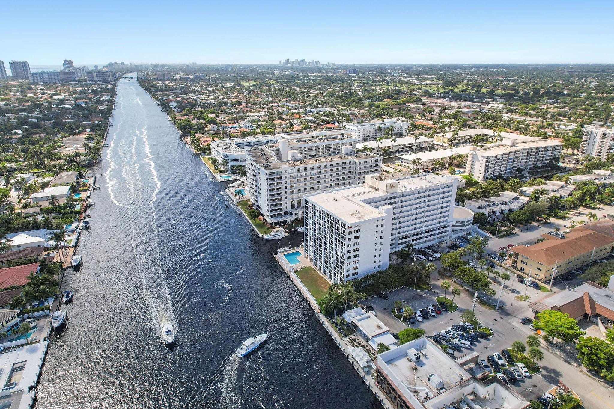 Views from every window! Large SW corner penthouse condo located steps away from the Commercial Blvd bridge entrance into LAUDERDALE BY THE SEA. New kitchen, floor to ceiling impact windows, and recent bathroom updates. Only one neighboring condo next door is divided by a solid concrete block wall, providing excellent sound insulation from next door. No neighbor above! Garage parking and ample guest parking. Common area, no fixed bridge/ deepwater dockage is available. Small pets are welcome. Building went through extensive concrete restoration and the roof was replaced in 2025. Great walkability to many restaurants, services and to the beach. Amazing sunsets and downtown views to the southwest and views to the ocean above 3 story height restricted, LAUDERDALE BY THE SEA, to the east.