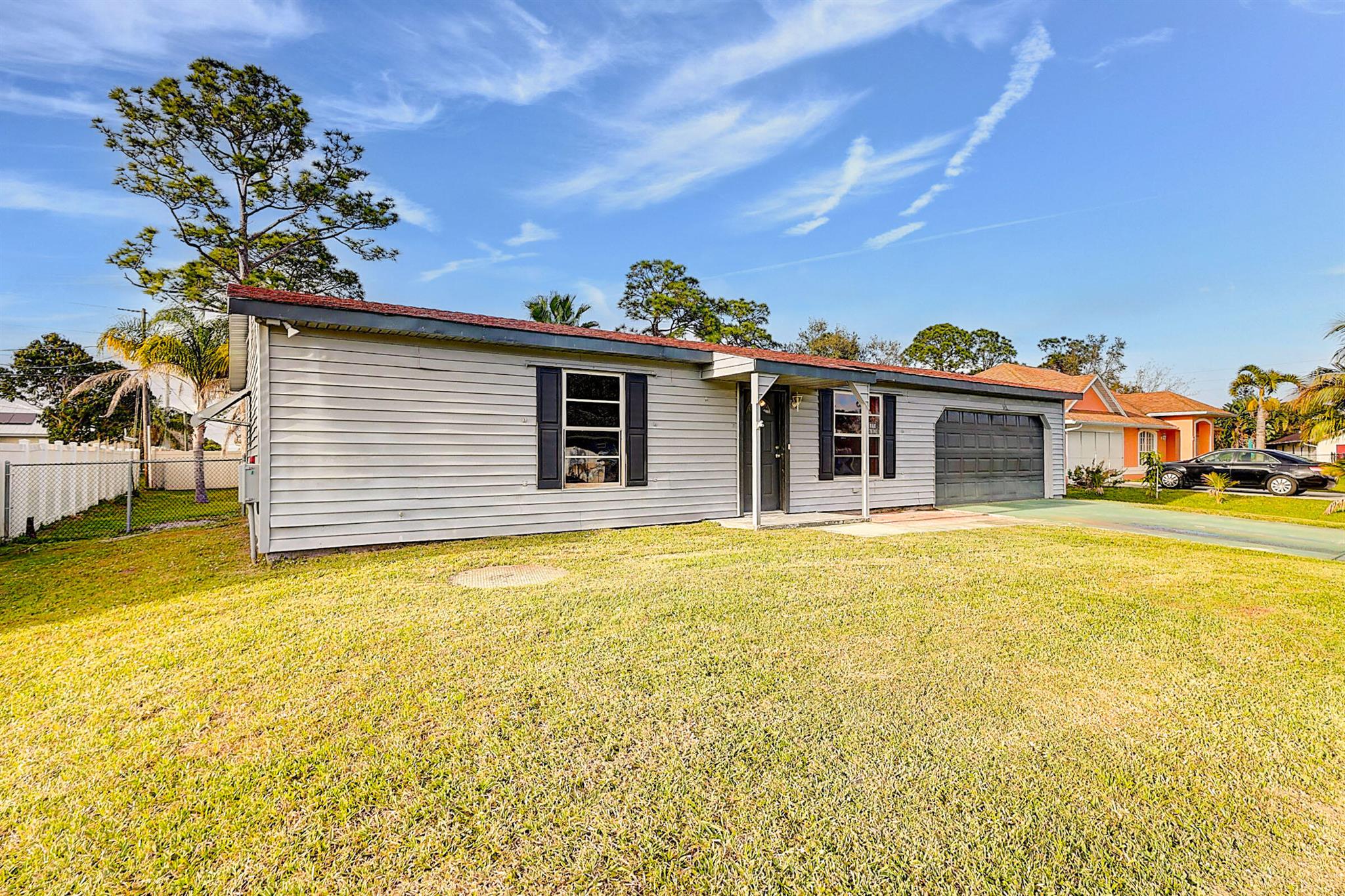 Must see this immaculate 2 Bedroom, 2 Bath home with a large extra room for additional bedroom or game room. Walk in closets in each Bedroom! Enjoy your completely fenced in backyard with a newer shed, AC and a full Hurricane shutter package. In the heart of Port St. Lucie, this home is convenient to everywhere. Motivated Seller! Schedule your showing today!