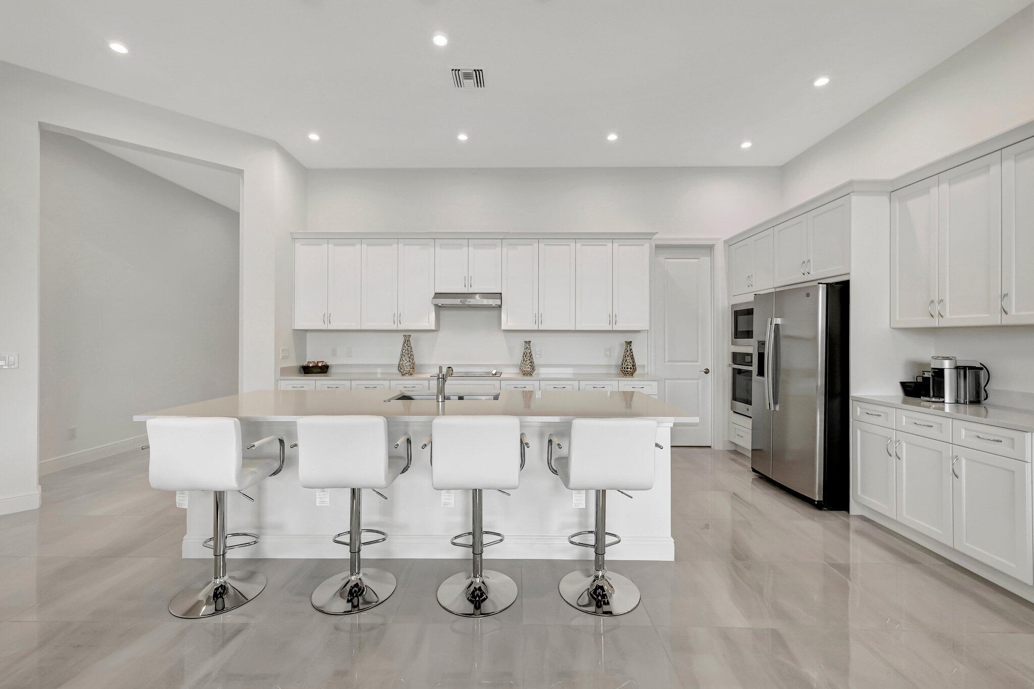 Don't wait to build, move into this gorgeous 2024 3BR/2BA/2CG Julia including exquisite upgrades. Split kitchen, quartz countertops, upgraded cabinets, extended lot with long lake views, ready for a pool! 16'x10' sliders, sparkly porcelain floors, master bath full wall mirrors, gutters, full impact windows with curtains, and so much more!Verano is an amenity rich community with a 27 court pickleball facility, indoor/outdoor pools, state of the art fitness facilities, social clubhouse, dog park and more. For avid golfers, there is a cart path leading to PGA Golf Club (membership is optional). HOA includes security, lawn care, cable, internet and access to all amenities. This community truly has something for everyone. Call today and start enjoying resort style living.