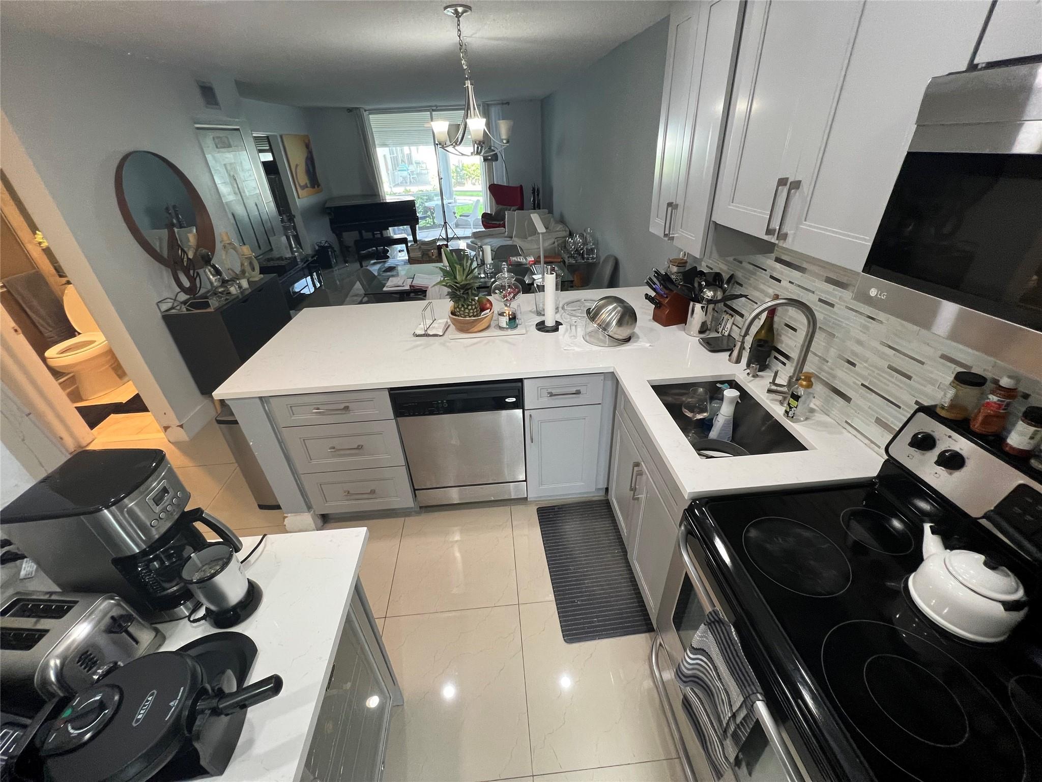 All ages, Pets(Service) friendly, walking distance to Pharmacies, banks, coffee places, grocery stores, Just 1,5 mile from the Beach. This First floor 2 bedroom 2 bath is remodeled and its a breath taking unit. Parking spot just by your front door. Accordion hurricane shutters. All furniture negotiable. No carpet at all. Open concept kitchen, like new stainless steel appliances. Great school district. Raise a family here or invest. Close to all you need very easy access to all main highways yet in a quiet neighborhood. Screened patio for your enjoyment, this will go fast, come see it today and make it home. Perfect location...building has elevator even though its a first floor unit. Pool, Gym, etc...Flexible seller...English, Espanol, Portugues.