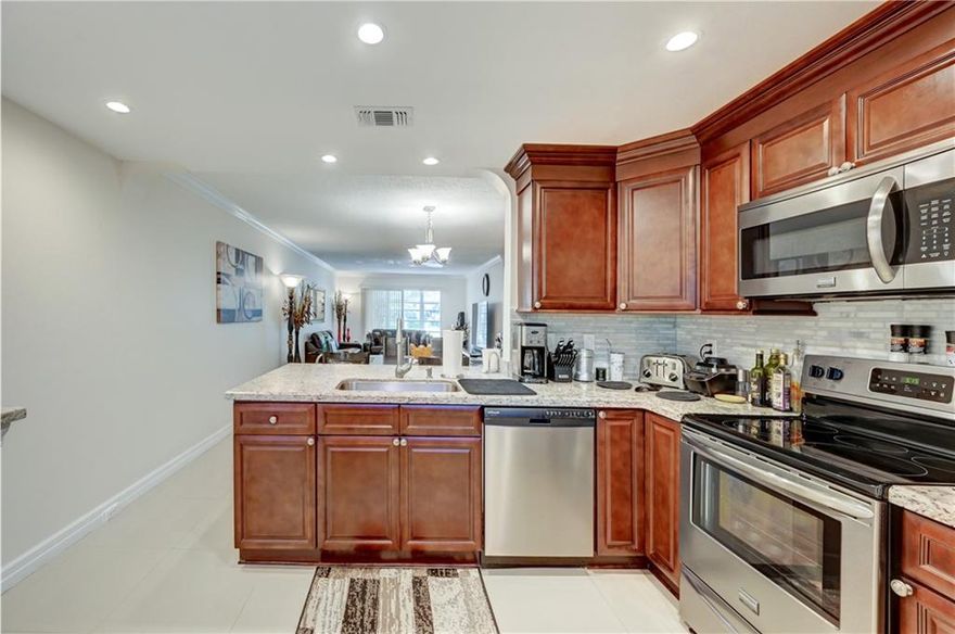 DESIRABLE GROUND FLOOR WITH AMAZING POOL/GARDEN VIEW AND PARKING SPACE RIGHT OUSIDE THE DOOR. BEAUTIFUL PORCELAIN FLOORS THROUGH-OUT. OPEN KITCHEN WITH NEWER KITCHEN CABINETS, GRANITE COUNTER TOPS AND SS APPLIANCES.  EXTENDED COUNTER TOP MADE FOR A BAR AREA IN DINING. NICE UPDATED BATHROOMS WITH NEWER VANITIES + TOILETS + LIGHTING. NEWER SHOWER IN GUEST BATHROOM. CROWN MOLDING ALL AROUND. NEW CLOSETS DOORS. ENJOY THE TRANQUIL AND PRIVATE VIEW FROM PATIO USING THE BACK DOOR. ENCLOSED PATIO WITH JALOUSIE WINDOWS. A MUST SEE. PLEASE SEE BROKER REMARKS. SQ FT MAY BE BIGGER BASED ON ENCLOSED PATIO.  ASSOC REQUIRES 20% DOWN & 1 OCCUP 55+ VACANT/CLICK ON SHOWING ASSIST