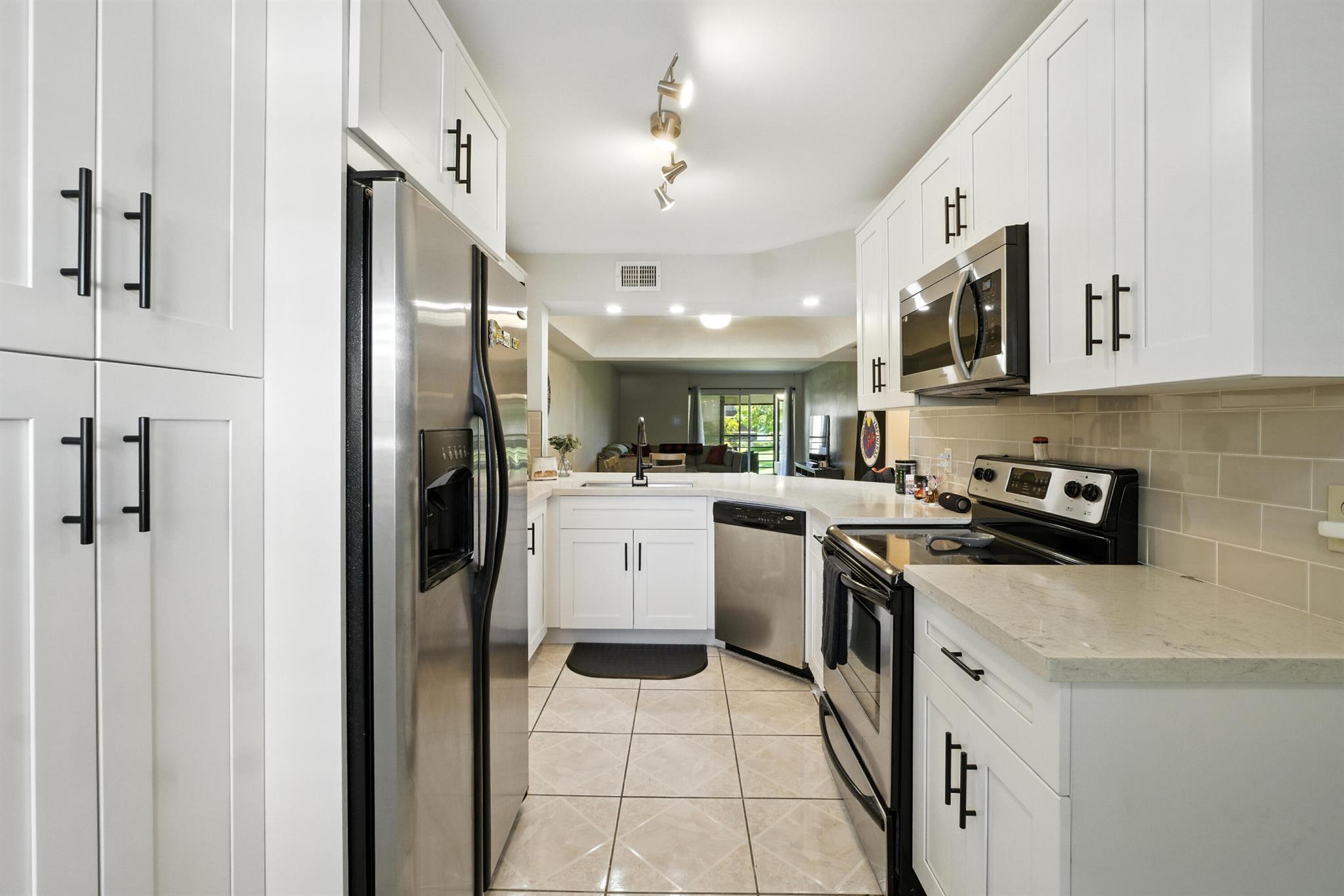 BEAUTIFUL 2/2 condo kitchen completed updated 2 yrs ago on the 2nd floor. Kitchen with white cabinetry & GORGEOUS granite countertops. Cozy breakfast nook and formal dining area. A/C and WATER HEATER. 2 yrs old. Spacious Master Suite, Oversized customed Walk-in Closet, new bath tiles , Newer Vanities, Custom Tilework, Modern Lighting, Generous Guest Room. Slide open the glass door and relax on the screened balcony that has shutters, overseeing a breathtaking view of the beautiful pool, garden & lake.