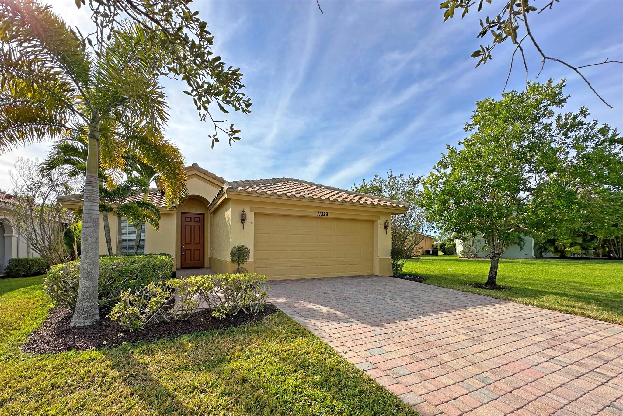Stunning Home located in the highly sought-after Vitalia at Tradition Community, this beautifully maintained 2-bedroom, 2-bathroom, 2-car garage home offers comfort, style and a vibrant 55+ active lifestyle. The spacious, sunlit living area features tile flooring throughout the main areas, and plush carpeting in the bedrooms for added warmth. A gourmet kitchen with ample cabinetry and counter space provides the perfect setting for cooking and entertaining. The primary suite is a private retreat, complete with large closets and a spa-like en-suite bathroom with a walk-in shower. This home offers peace of mind with hurricane impact windows, 2024 AC, and a gas water heater and stove. The house exterior has been freshly painted. Barrel tile roof adds to its timeless curb appeal.