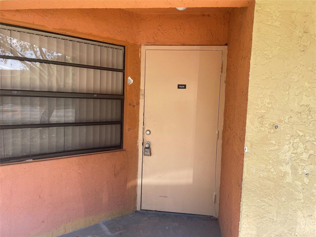 Photo of 4164 Lakeside Drive, Tamarac, FL 33319 (MLS # F10432258)