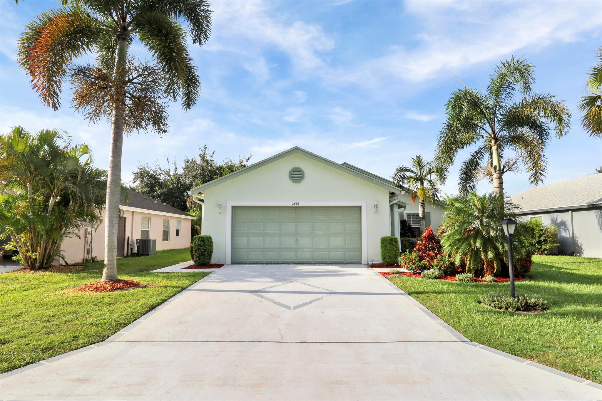 Welcome to your Florida getaway! This 3 bedroom, 2 bathroom, 2-car garage home in the St. Lucie Falls 55+ age community features a split floor plan with vaulted ceilings and open living spaces. The kitchen shines with granite countertops, tile backsplash, stainless steel appliances, and a breakfast bar. The primary suite offers a walk-in closet and private bath with dual sinks and walk-in shower. Step outside to the large extended screened patio--perfect for entertaining, relaxing, or enjoying the Florida breeze. New A/C (2023). Resort-style amenities includes 2 pools, clubhouse, tennis, pickleball, fitness room, billiards, bocce ball, gated boat/rv storage, community boat launch and endless social activities!