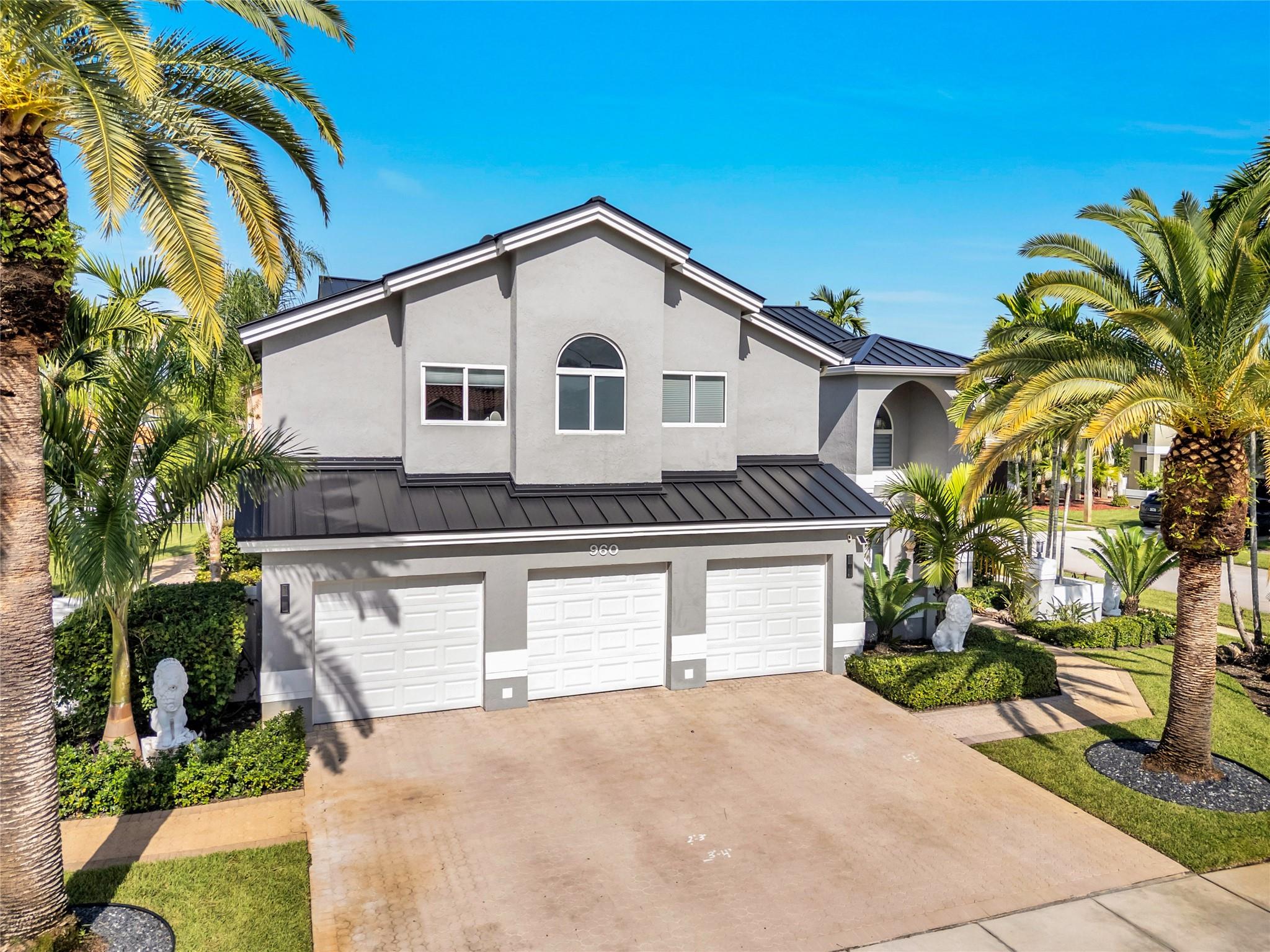 Welcome to this beautifully renovated 4-bedroom, 3-bath home where pride of ownership shines. With 3,292 sq ft of living space on an oversized corner lot, it offers a spacious layout and peace of mind with a new metal roof (transferable warranty) and full impact windows & doors. Inside: updated bathrooms, stylish kitchen, new electric panel, tankless water heater, LED recessed lighting, and smart-home controls for locks, garage, 2 ACs, lighting, and sprinklers. 48x48 porcelain floors downstairs, laminate upstairs, custom closets, and neutral finishes create a timeless look. One bedroom and full bath on the first floor, plus a primary suite with bonus room for office/nursery. Dual laundry setups and an EV-ready garage add convenience. Resort-style amenities complete this move-in ready home