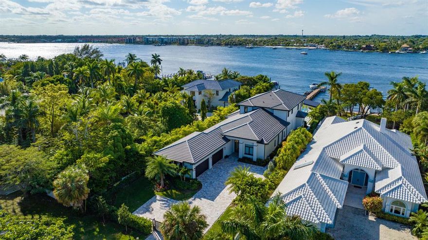 Built in 2022 and never lived in by its first owners, this designer appointed, furnished, direct-Intracoastal modern estate lives like brand-new construction. Offering an impressive sense of arrival, the front entry gates open to the brick-paved motor court set amidst lush tropical landscaping, and in the backyard, nothing is left wanting in this entertainers delight. Here, two loggias and a fully-equipped summer kitchen are adjacent to the sun-dappled, oversized salt-water infinity-edge pool dramatically inset with a spa, sun shelf, bar and sunken fire pit.  An arbor enhanced by a cascading waterfall provides another striking focal point, and attractive to water-sports enthusiasts with 75+/- feet on the intracoastal Waterway and direct ocean access with no fixed bridges. South Atlantic Drive, Lantana, Florida.  Hypoluxo Island preserves Old Florida tranquility on a scenic barrier island surrounded by the Intracoastal Waterway in the heart of South Florida's Gold Coast, midway between Palm Beach and Boca Raton.  Just across the bridge is the sugar-sand ocean beachfront of Manalapan, home to the Five-Diamond Eau Palm Beach Resort & Spa.
 
PROPERTY:

Offering an impressive sense of arrival, the front entry gates open to the brick-paved motor court set amidst lush tropical landscaping, and in the backyard, nothing is left wanting in this entertainers delight. Here, two loggias and a fully-equipped summer kitchen are adjacent to the sun-dappled, oversized salt-water infinity-edge pool dramatically inset with a spa, sun shelf, bar and sunken fire pit.  An arbor enhanced by a cascading waterfall provides another striking focal point, and attractive to water-sports enthusiasts with 75 feet on the intracoastal Waterway and direct ocean access with no fixed bridges, the full-service dock is equipped with boat and wave-runner lifts.

RESIDENCE:  

Unparalleled luxury, elegance and drama hallmark this exciting furnished six-bedroom, 8,086 +/- total-square-foot modern estate, where features include posh wood-look tile flooring, designer ceilings, a collection of handsome moldings, custom built-ins and plush upholstered accent walls. Introducing this opulent estate, double glass doors open to the foyer, stair hall and gallery, flowing past the mood-setting living room, featuring a suede-covered accent wall and a custom built-in media center finished in stone and wood, and culminating at the open-concept dining room and kitchen. A focal point in the dining room is a large wet bar and glass-fronted wine fridge, and for seamless indoor/outdoor entertaining, a wall of pocket sliding doors open to the loggia and summer kitchen overlooking the pool with a wide view of the Intracoastal as a backdrop. Sure to gratify the chef, the cook-island gourmet kitchen is fitted with custom cabinetry, professional-grade Thermador stainless appliances, backlit Cristallo countertops, and a walk-in pantry. All bedroom suites are incredibly luxurious, but the two primary bedroom suites located on the first and second floor, are truly oases of serenity, with one accessing a poolside loggia, and the other opening to a large balcony. Highlights include custom built-ins, lavishly upholstered accent walls, a morning bar, huge custom-fitted walk-in closets and quartz-finished, spa-inspired bathrooms, each fitted with dual vanities, a soaking tub, and walk-through multi-head showers. Of the guest-bedroom suites, the VIP suite features wood-paneled and plush-suede accent walls, and another, featuring a mirrored wall, serves as a gym and wellness suite. Completing the overall floor plan are an elevator, half-bath, two laundry rooms, and a four-car poly-coated garage with double height for car lifts and includes high-end built-in cabinetry. Amenities include hurricane-impact windows and doors, natural gas, tankless hot-water heaters, backup generator, full house water filtration system, and a concrete tile roof. Offering a contemporary aesthetic that combines design, form and function to perfection, this rare masterpiece is a true work of art.

The information herein is deemed reliable and subject to errors, omissions or changes without notice.  The information has been derived from architectural plans or county records. Buyer should verify all measurements. 

DISCLAIMER: Information published or otherwise provided by the listing company and its representatives including but not limited to prices, measurements, square footages, lot sizes, calculations, statistics, and videos are deemed reliable but are not guaranteed and are subject to errors, omissions or changes without notice. All such information should be independently verified by any prospective purchaser or seller. Parties should perform their own due diligence to verify such information prior to a sale or listing. Listing company expressly disclaims any warranty or representation regarding such information. Prices published are either list price, sold price, and/or last asking price. The listing company participates in the Multiple Listing Service and IDX. The properties published as listed and sold are not necessarily exclusive to listing company and may be listed or have sold with other members of the Multiple Listing Service. Transactions where listing company represented both buyers and sellers are calculated as two sales. The listing company's marketplace is all of the following: Vero Beach, Town of Orchid, Indian River Shores, Town of Palm Beach, West Palm Beach, Manalapan Beach, Point Manalapan, Hypoluxo Island, Ocean Ridge, Gulf Stream, Delray Beach, Highland Beach, Boca Raton, East Deerfield Beach, Hillsboro Beach, Hillsboro Shores, East Pompano Beach, Lighthouse Point, Sea Ranch Lakes and Fort Lauderdale. Cooperating brokers are advised that in the event of a Buyer default, no financial fee will be paid to a cooperating Broker on the Deposits retained by the Seller. No financial fees will be paid to any cooperating broker until title passes or upon actual commencement of a lease. Some affiliations may not be applicable to certain geographic areas. If your property is currently listed with another broker, please disregard any solicitation for services. Copyright 2023 by the listing company. All Rights Reserved.
