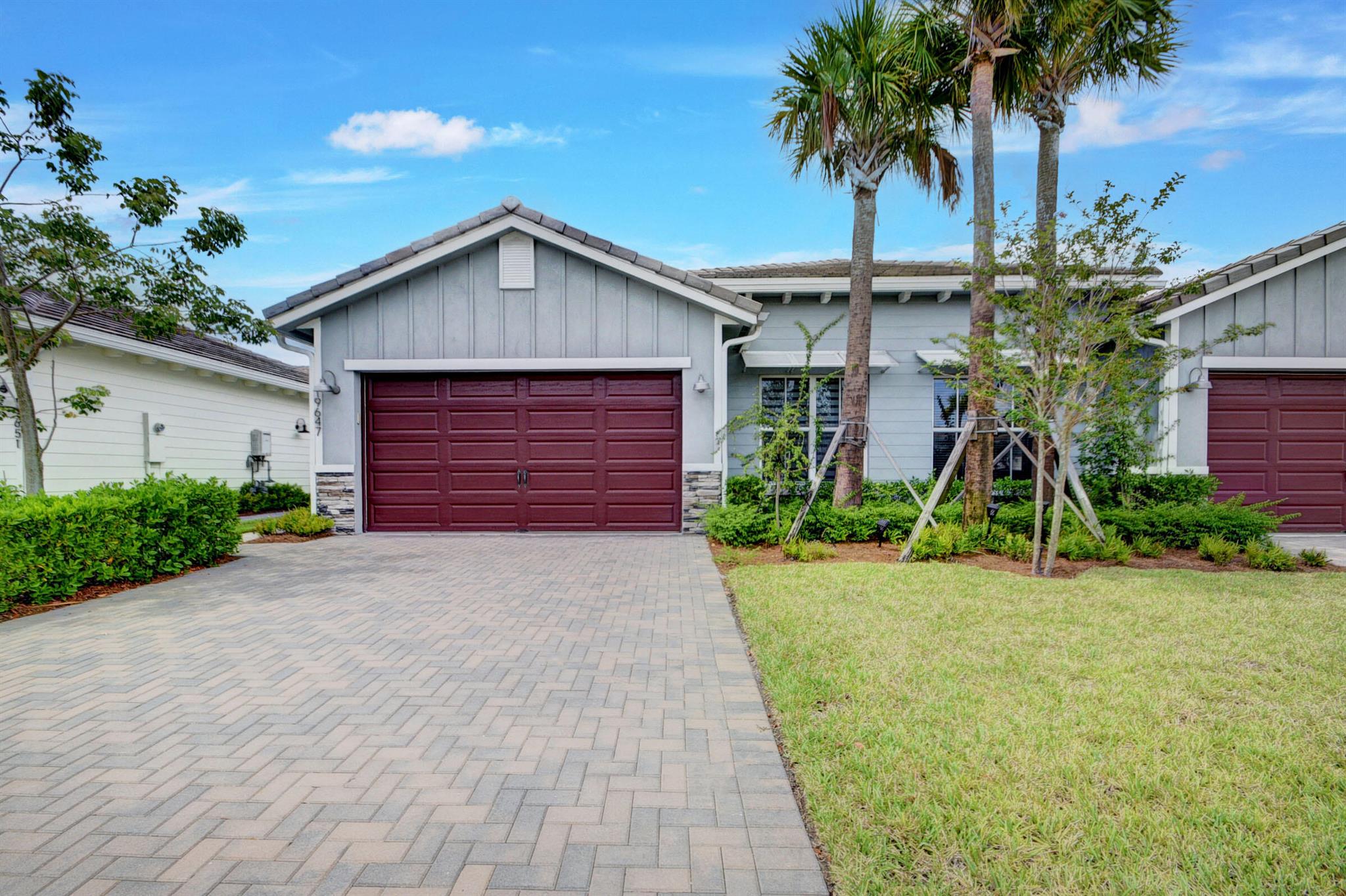 Welcome to Arden Agrihood! Experience the serenity, comfort, and elegance of this beautiful 2021 villa. It features an all-white kitchen with quartz countertops, custom blinds, wood-look tile flooring, and a covered patio overlooking lush greenery to the North. Enjoy the luxurious primary suite with two walk-in closets and an en-suite bathroom that includes a step-in shower, separate WC, and dual sink vanity. The split bedroom plan provides privacy, with two additional bedrooms plus a den. The washer and dryer are conveniently located in a separate hallway closet, making laundry easy. Arden's unique community offers parks, playfields, trails, a farm, a pool, a fitness center, and a lovely lake for fishing. Plus, it is zoned for some of the best schools in Palm Beach. Ready for move-in!