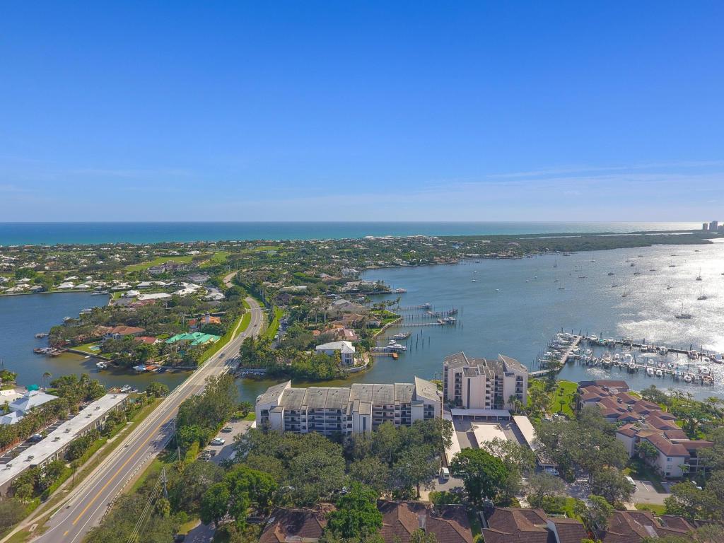 BEAUTIFULLY UPDATED TOP FLOOR CONDO WITH VAULATED CEILINGS AND STUNNING KITCHEN WITH BREAKFAST AREA. FULL GUEST SUITE WITH BATH AND FULLY LAUNDRY IN UNIT. MASTER HAS GORGEOUS VIEWS OF THE INTRACOASTAL DOWN TO SINGER ISLAND. 1 COVERED PARKING SPACE AND ACCESS TO TWO POOLS, TENNIS, PICKLE AND CLUBHOUSE. WALK TO STARBUCKS, PUBLIX AND SEVERAL AREA RESTAURANTS. POSSIBLE BOAT SLIPS TO RENT THATS HARD TO FIND