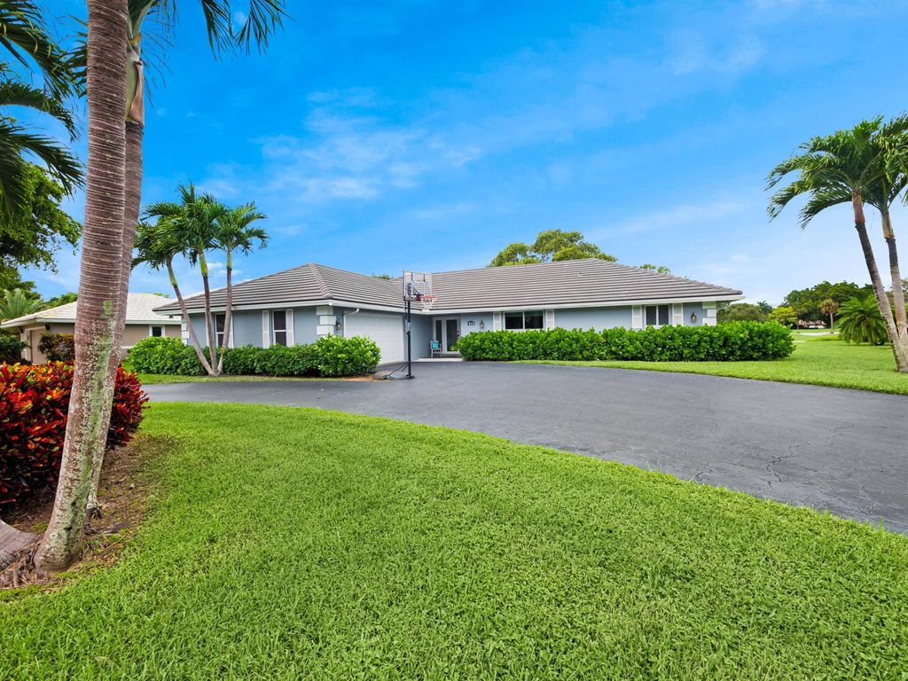 Photo of 413 S Country Club Drive, Atlantis, FL 33462 (MLS # R10930961)