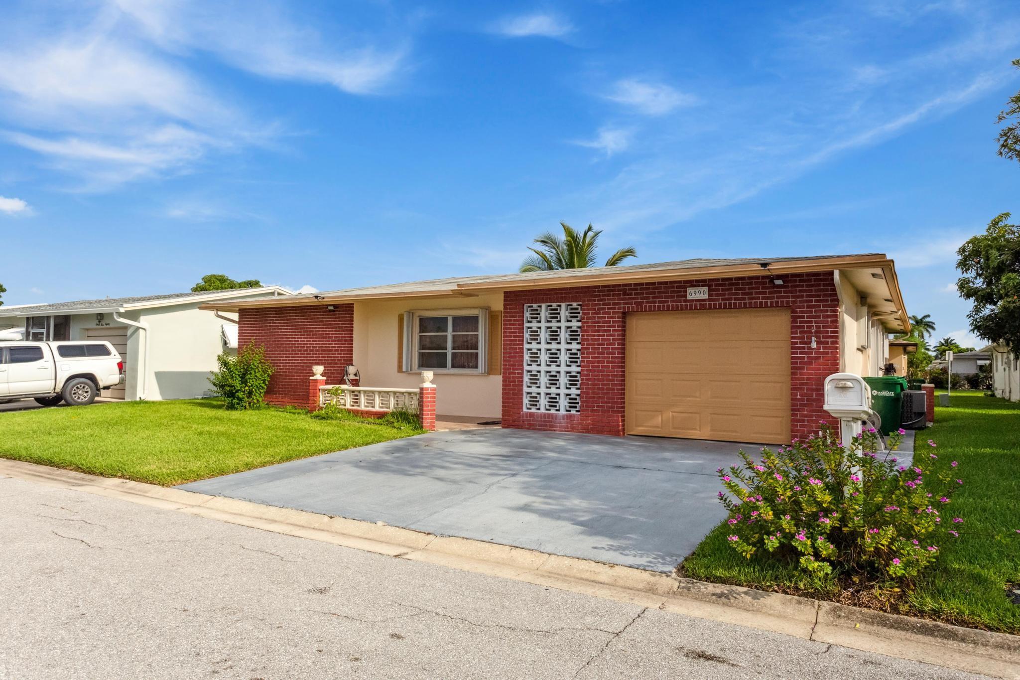 Discover this spacious 2-bedroom, 2-bathroom home with an additional versatile room. The master bedroom boasts separate his and hers closets, adding a touch of luxury. Recent enhancements include an updated bathroom and stylish laminate flooring throughout all bedrooms. Enjoy peace of mind with hurricane impact windows throughout the property. The washer and dryer were replaced in 2025, the AC system in 2021. Outside, you'll find beautiful fruit trees. Conveniently located near highways and major retail stores, this home offers both comfort and accessibility. Make an appointment for showing via showingtime.