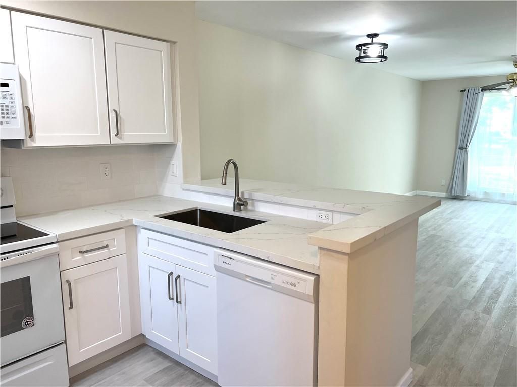 Photo of 2216 N Cypress Bend Drive #210, Pompano Beach, FL 33069 (MLS # F10473536)