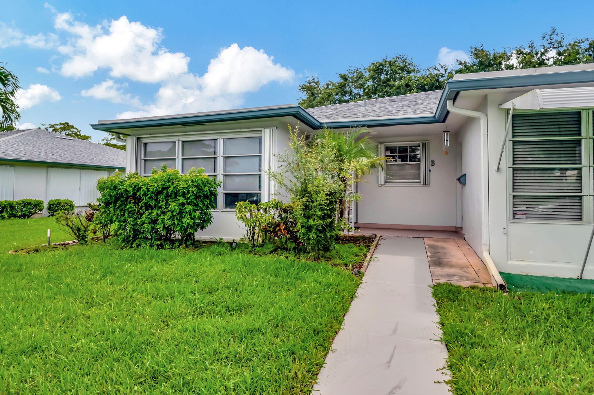 Step into this stunning 2 bedroom, 2 bath villa, where modern elegance meets comfortable living. The versatile den offers the perfect space for work, creativity, or relaxation. Upon entry, the inviting Florida room / porch greets you with serene views, creating a peaceful retreat to enjoy your morning coffee. The kitchen is a chef's delight, featuring sleek updated cabinetry with ample storage, luxurious countertops and a stylish tiled backsplash. The open and spacious layout is ideal for both entertaining and everyday living. This beautifully renovated end unit, in Delray Beach, boasts modern bathrooms, recessed lighting and elegant flooring.