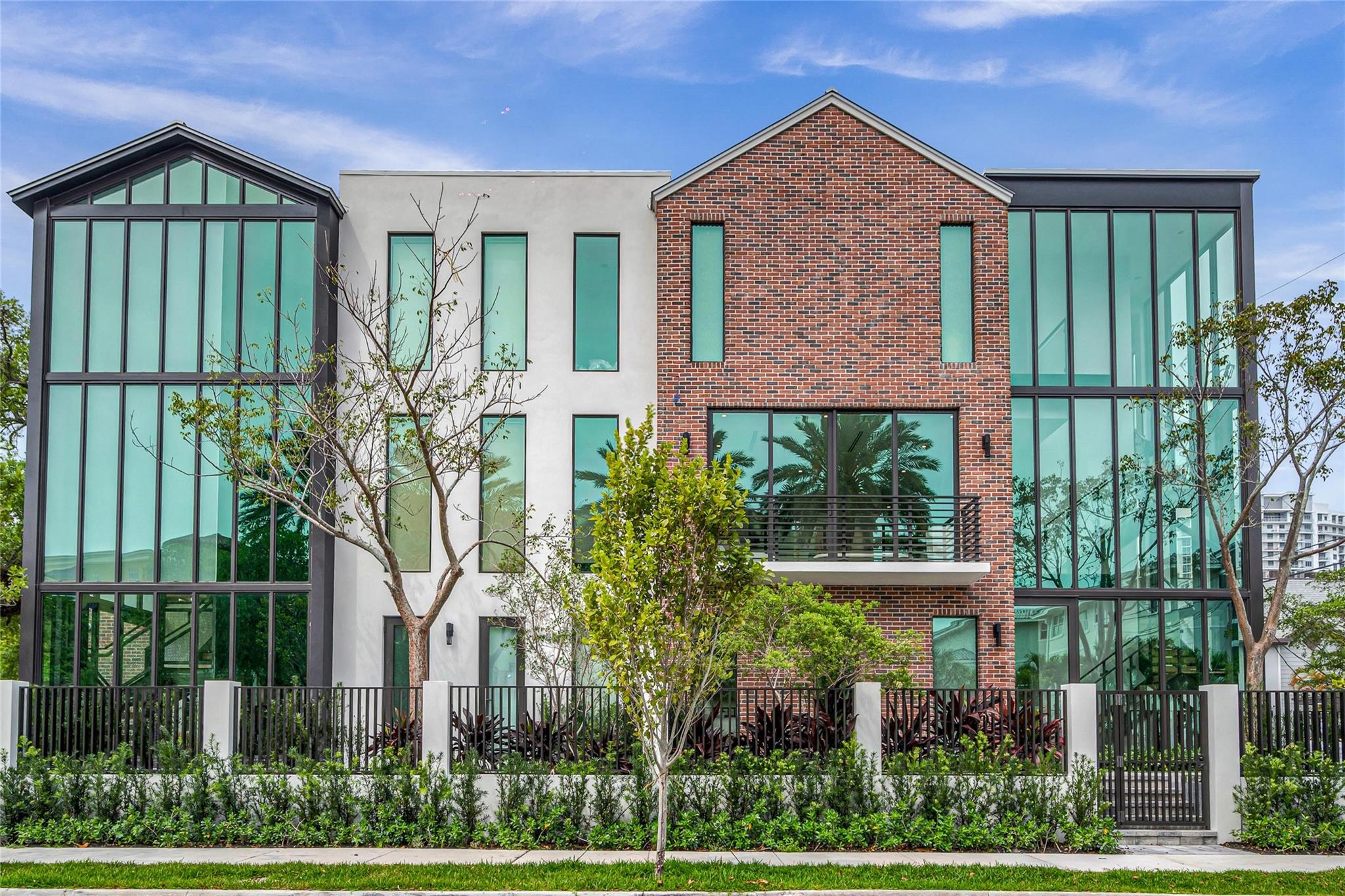 NEW CONSTRUCTION In the heart of EVERYTHING! Steps to Las Olas is this Industrial Modern 3 bed, 3.5 bath light-filled townhouse with elevator. The ground floor features gated courtyard, 2 ensuite guest rooms, 2 car garage, entry foyer with dramatic staircase. The 2nd floor is the main living area w/ expansive living room opening on to a balcony, custom kitchen w/ Jennaire appliances, quartz waterfall counters & breakfast bar, lighted cabinets & shelving. The Dining room features floor-to-ceiling windows, powder room and full-sized laundry room with work sink. The third floor is the primary suite with sitting room and large terrace with incredible city views. Wide plank White Oak flooring throughout. Comes with a 1 year builder warranty, Smart Home wired Habitus Furniture avail for purchase