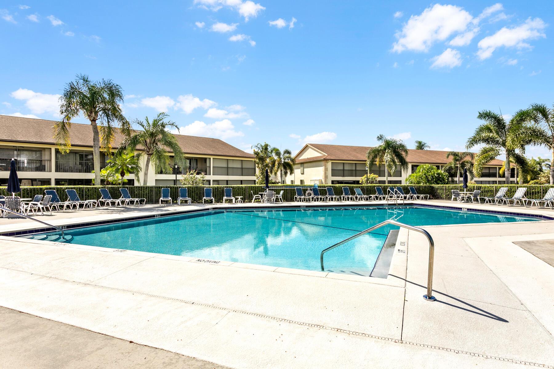 This first floor, immaculate and move-in ready condo is located on the 8th hole of the Golf Club of Jupiter. It features two bedrooms, two full baths and two walk-in closets. The kitchen boasts custom cabinetry, granite countertops and upgraded stainless appliances. Spacious, open concept living room and dining area complete with wet bar and wine cooler open to large screened porch with beautiful views of pond and eighth green. The unit has hurricane-proof windows and accordion shutters for the porch. New air conditioning was installed in 2023 and hot water heater in 2022. The HOA fees cover water, sewer and cable. Renting is permitted after one year of ownership. Residents can enjoy golf, tennis, pickleball, heated pool and clubhouse all surrounded by beautifully manicured grounds