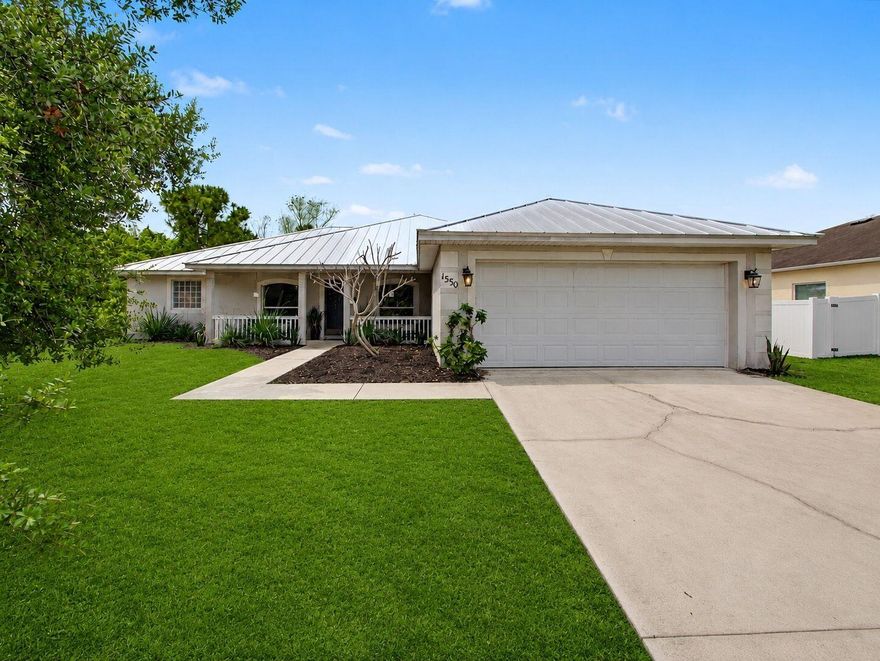 If you are looking for a CBS home in a great location in the southern part of Port St. Lucie, this is it! Great location with over 2,000 sq ft under air. Seamless metal roof replaced in 2022. Move-in ready 3 bed, 2 bath with a versatile floor plan, including a separate formal dining room and/or office at the front of the home. Huge family room with eat-in kitchen area. Large backyard. Vinyl floors throughout and vaulted ceilings. Split floor plan with well-appointed primary suite featuring dual closets, double vanities, and separate shower and tub. Murphy bed in 2nd bedroom, large interior laundry room, upgraded lighting, ceiling fans, and appliances. Front porch and large driveway. Close to shopping, dining, schools, and highways great for commuters. Don't miss this one!