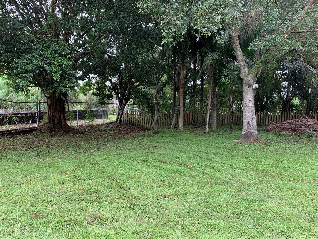 Welcome to your totally secluded piece of paradise! This beautiful, well prepped lot, is ready for your final touches. Cleared, well landscaped, with beautifully aged trees & a pond! Store your RV, boat, cars, toys, etc. here under your 20 X 40 Pole Barn! This property includes a shed/barn at the rear of the property with enclosed area. Only one neighbor accesses your private roadway & the property is bordered by a flower nursery! Enjoy views of roses & other flowers in the spring months! This lot has been filled to be high & dry & includes WELL, SEPTIC, ELECTRIC, & CABLE ON SITE. Plug & Play your RV /Camper with the 50 AMP Power Outlet on site as well. Contact Martin County for approved uses & development questions. ALL information herein to be verified by buyer.