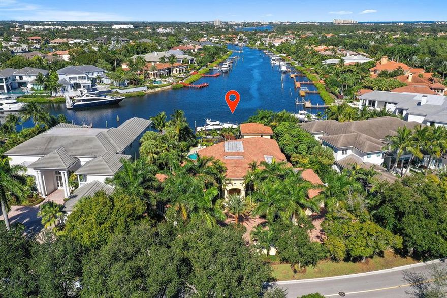 Incredible long and expansive water view from this magnificent custom estate home. This home is on over .6 acres on one of the most extraordinary waterfront properties in Admirals Cove. This 5 bedroom, 5 bath and 2 half bath home has been meticulously maintained and updated.  Huge Master bedroom suite with dual large walk-in closets and separate his/her water closets . One of the guest suites/bedrooms is a large housekeeper or in-law suite with kitchenette. Newly designed and installed state of the art kitchen with beautiful, spacious cabinets and large counter with bar seating flows into the breakfast area and extensive family room. Large den/office overlooking logia with huge views of the waterway. Oversized living room with floor to ceiling windows facing water view. Travertine marble floors throughout. New private  guest suite with private balcony built above the new summer kitchen with bar seating and electric sun shades. Majority of windows are new wind/hurricane resistant type. Roof is new. Panoramic water view from the all glass rear water view.  Newly landscaped  rear yard and logia area with high end pool and spa, large wrapping custom lanai and lounging area. Large master bedroom suite and bath with his and her water closets. Plenty of custom closets and storage throughout. This home is complete with well maintained, lush tropical landscaping and low voltage outdoor lighting bathing majestic Royal Palms overlooking the stately entrance.  Redesigned new paver driveway and turnaround center Island. 3 Car oversized garage with many storage closets as well as a separate golf cart garage and adjacent workout room. Deep water dock capable of holding up to a 55 foot boat or larger. Literally around the bend from the intracoastal waterway. Many more carefully thought out extras.