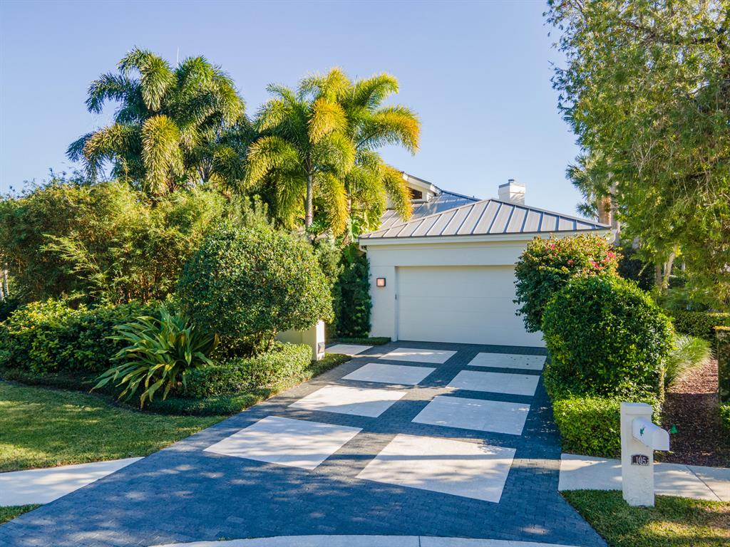 The Best of Country Club Living. A tropical oasis awaits you in this 3029 sf, 4 bedroom, 3 bath home located in the prestigious Loxahatchee Club in Jupiter. Enter this home from the custom pavered driveway through a meandering granite walkway with lush tropical foliage and a peaceful fountain. Step inside this home from the covered entry and be struck by the soaring dramatic ceiling in the great room and full feature stone wall. An adjoining dining room is light filled with windows with views to the outdoors. The kitchen is the heart of the home with custom cabinetry, quartz countertops and state of the art appliances. A sitting/work area is incorporated in this space with views to the tropical landscape and water feature outdoors. The main level master suite is sumptuous